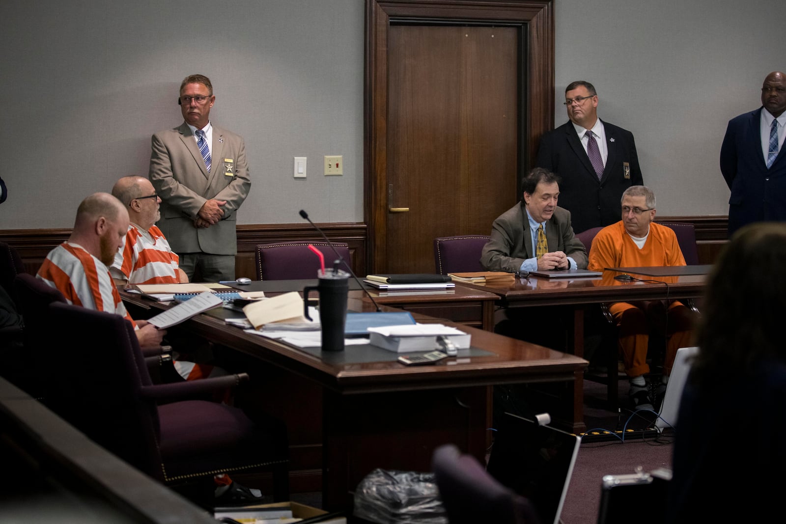 Travis McMichael, left, Greg McMichael, second from the left, and William "Roddie" Bryan, far right, sit at the defense table during a a hearing for a new trial, Thursday, Oct. 24, 2024, in Brunswick, Ga. (AP Photo/Stephen B. Morton)