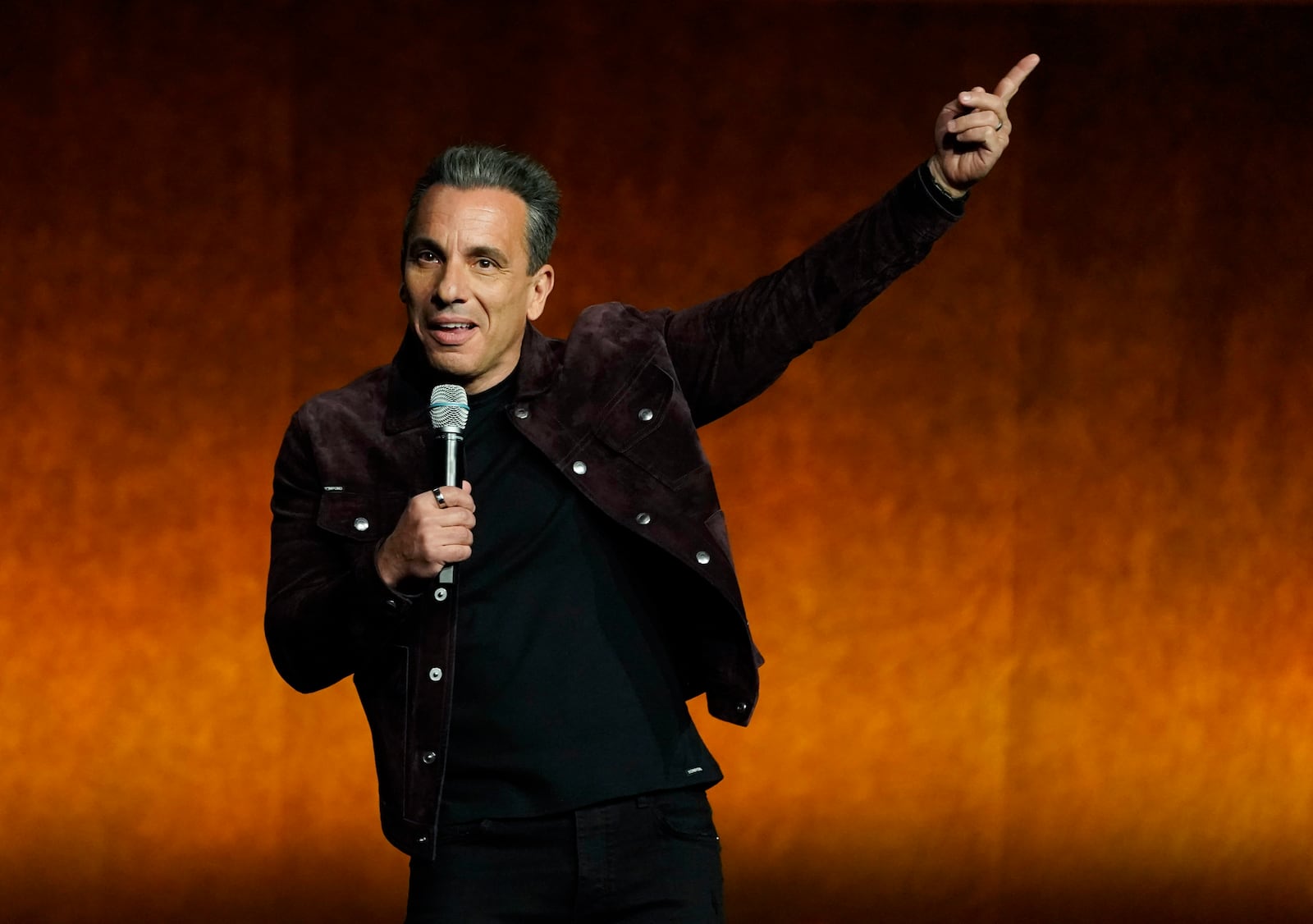 Sebastian Maniscalco, a cast member and co-writer of the film "About My Father," speaks from the stage during the Lionsgate presentation at CinemaCon 2022 at Caesars Palace, Thursday, April 28, 2022, in Las Vegas. (AP Photo/Chris Pizzello)