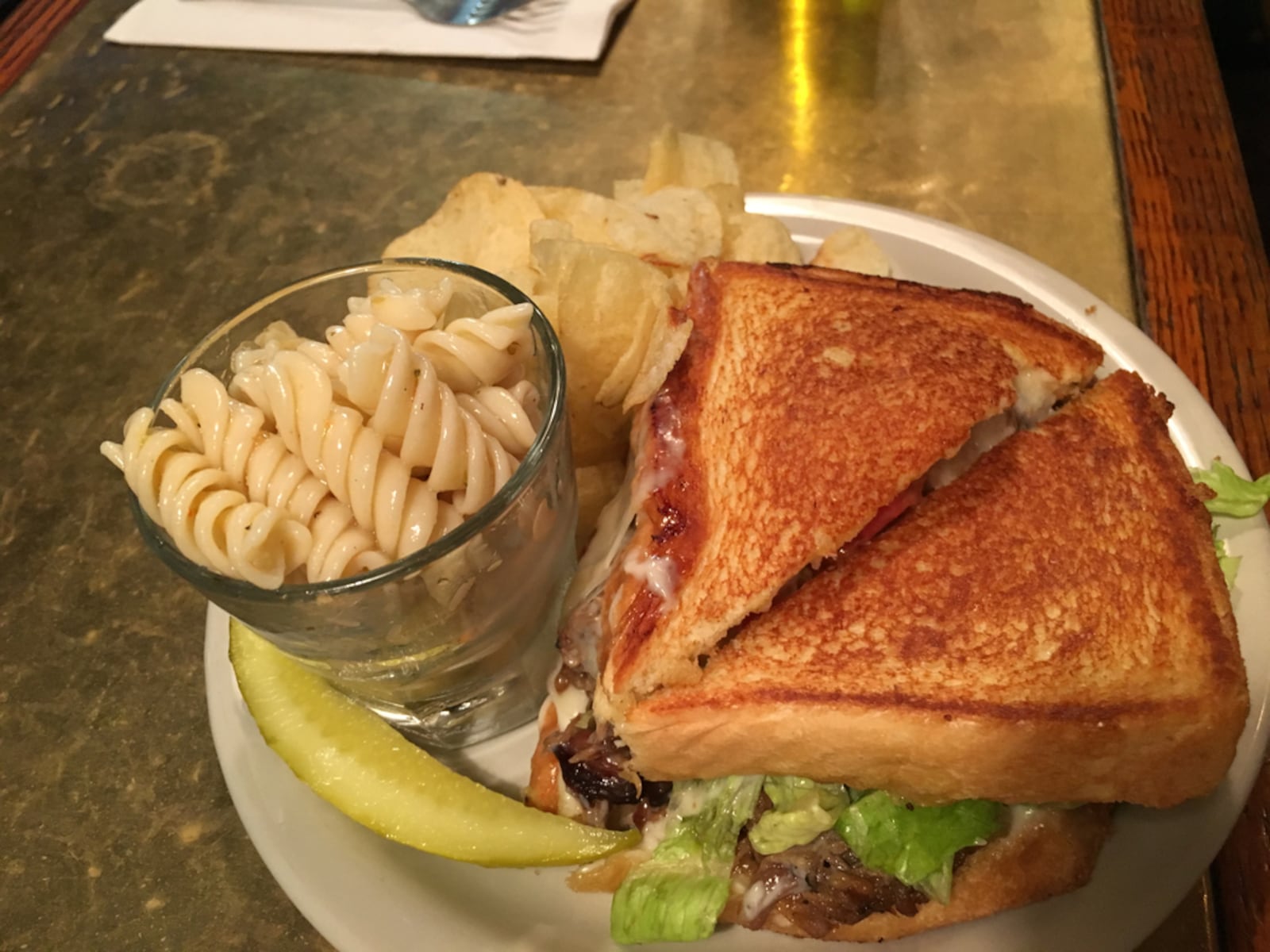 A Hannah's Bar and Restaurant beef sandwich with pasta salad, chips and a pickle.  Photo: Amelia Robinson, staff.