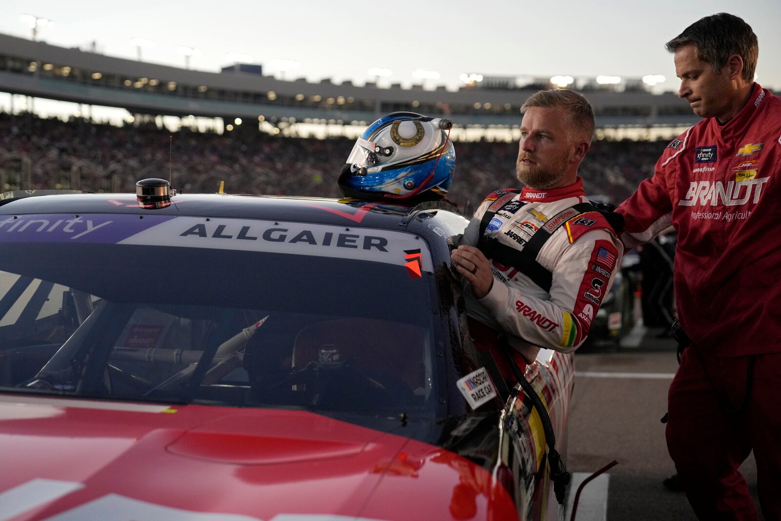 Justin Allgaier gets in his car before a NASCAR Xfinity Series auto race, Saturday, Nov. 9, 2024, in Avondale, Ariz. (AP Photo/John Locher)