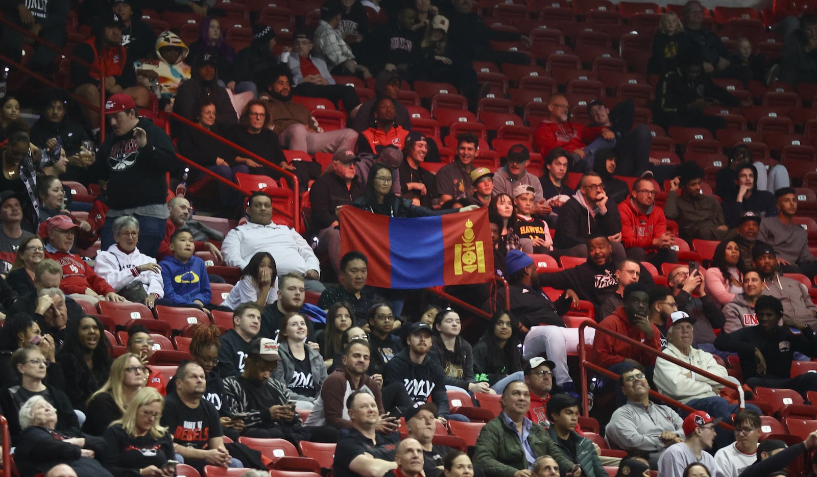 Fans hold up a Mongolian flag in honor of Dayton's Mike Sharavjamts during a game against UNLV on Tuesday, Nov. 15, 2022, at the Thomas & Mack Center in Las Vegas, Nev. David Jablonski/Staff