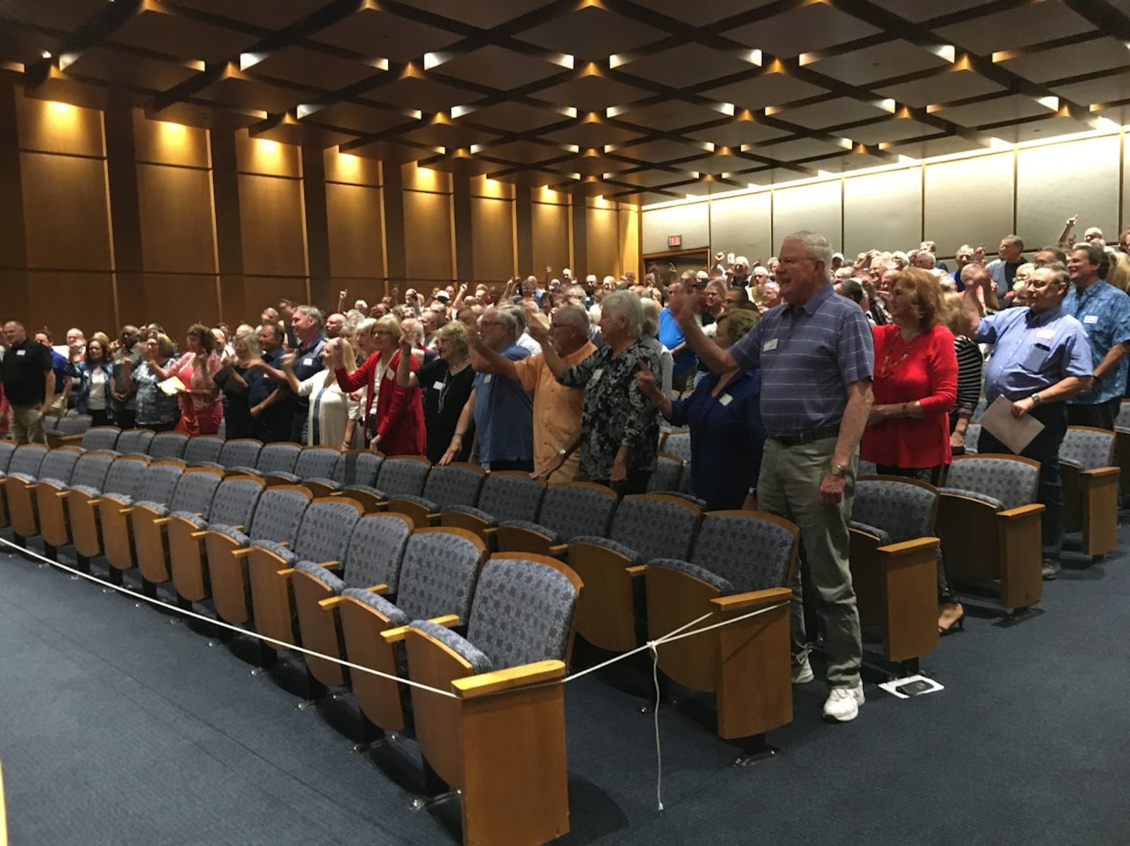 Members of the Delphi Salaried Retirees Association stood and chanted "Pass this bill" in September at a Sinclair Community College auditorium. THOMAS GNAU/STAFF