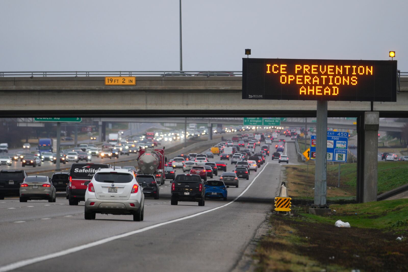 A sign warns motorists of road preparations ahead of frigid temperatures expected to drop below zero Tuesday, Feb. 18, 2025, in Arlington, Texas. (AP Photo/Julio Cortez)