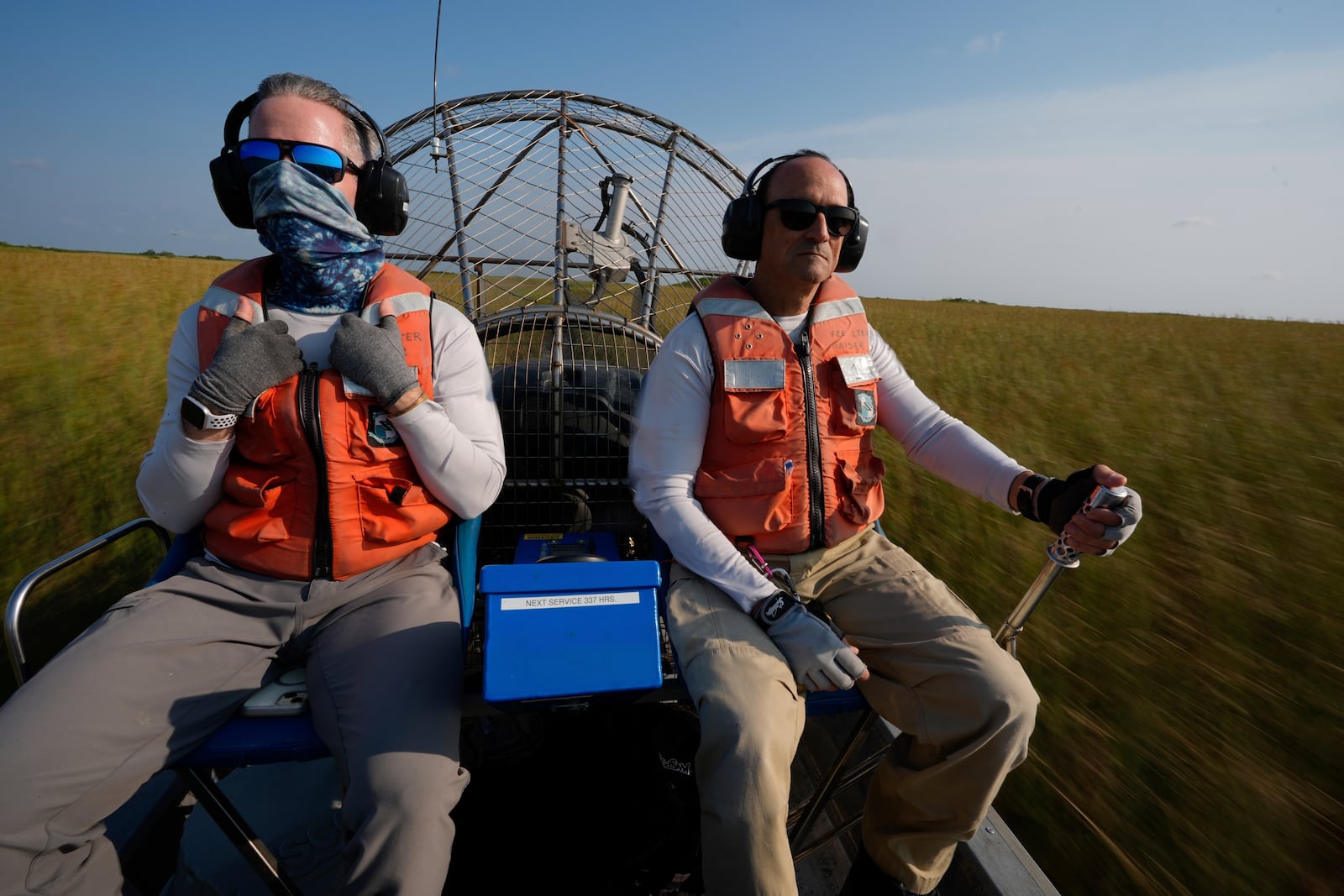 Florida International University professor John Kominoski, left, and research specialist Rafael Travieso travel by airboat through Shark River Slough on their way to collect water samples and maintain automatic sampling equipment in Florida's Everglades National Park, Tuesday, May 14, 2024. (AP Photo/Rebecca Blackwell)