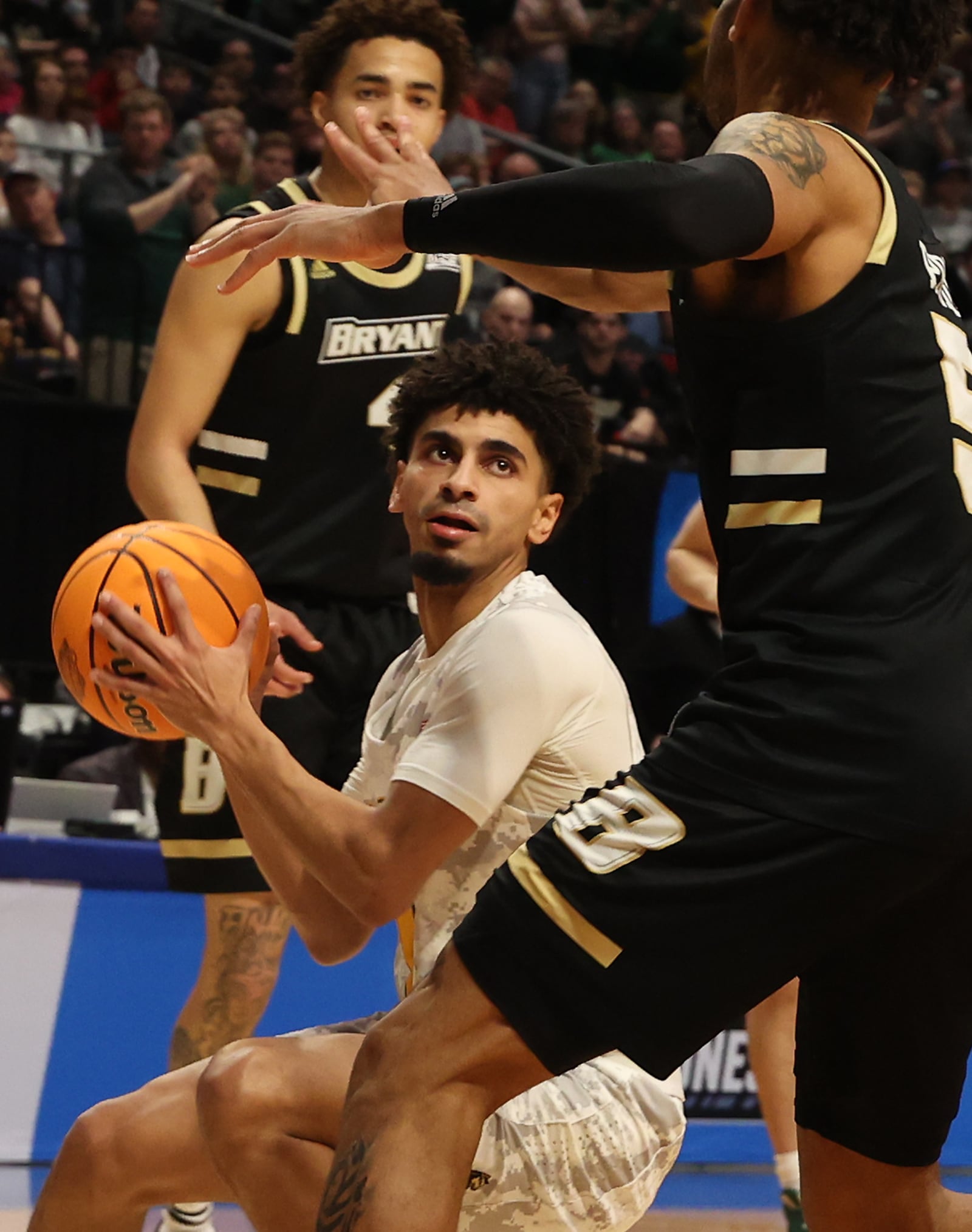 Wright State's Trey Calvin looks for an opening around Bryant's Charles Pride during the First Four game Wednesday, March 16, 2022. BILL LACKEY/STAFF