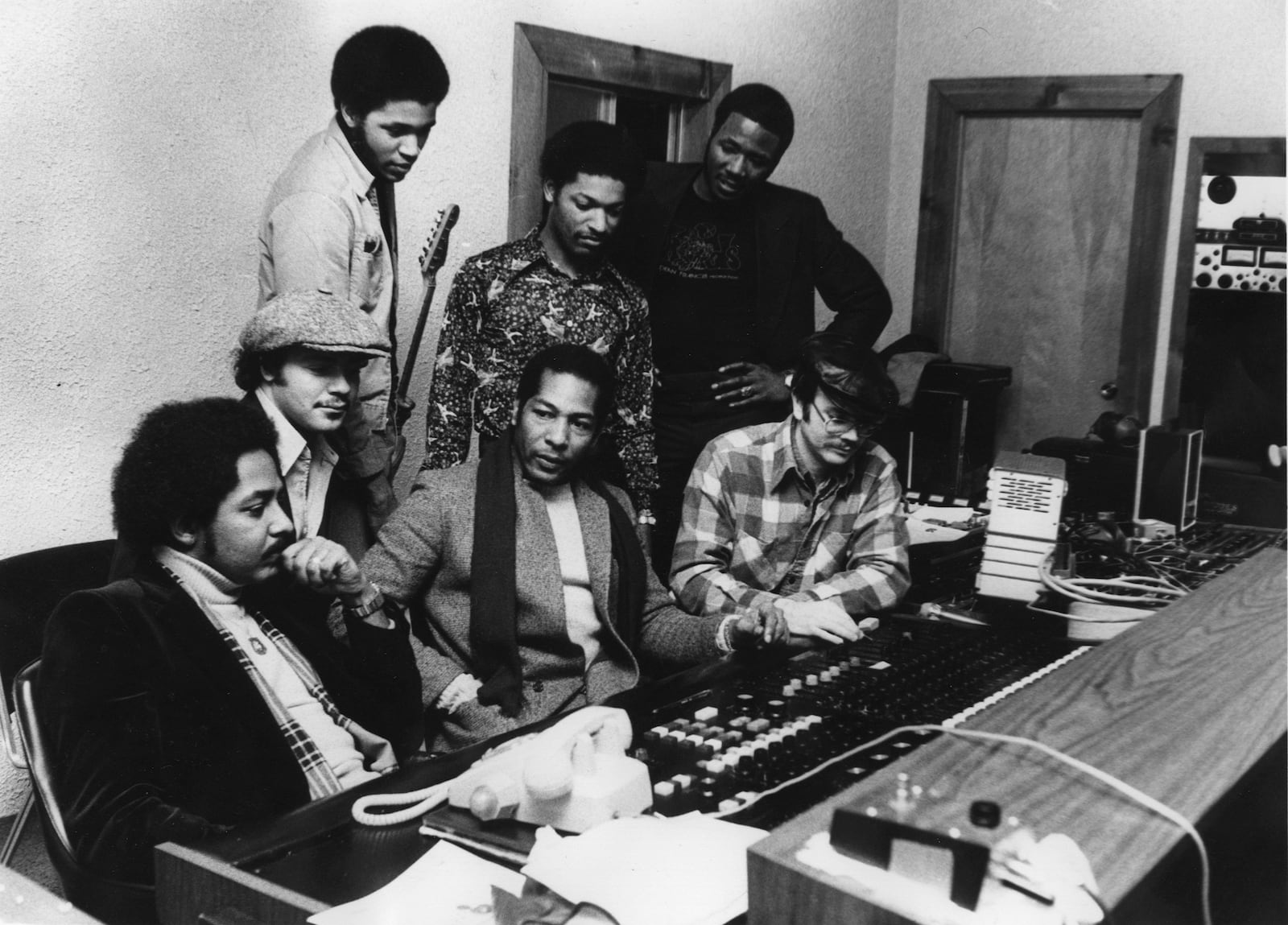 THE FUNK ROCK GROUP "SUN" LISTEN TO THEIR TAPE CYBERTEKNICS. FRONT ROW, L-R: DR. CECIL HALL, BEAU RAY FLEMING, PHILLIP MEHAFFEY; BACK ROW, L-R: BYRON BYRD, SHELTON REYNOLDS, VICTOR MARTIN, DEAN FRANCIS.