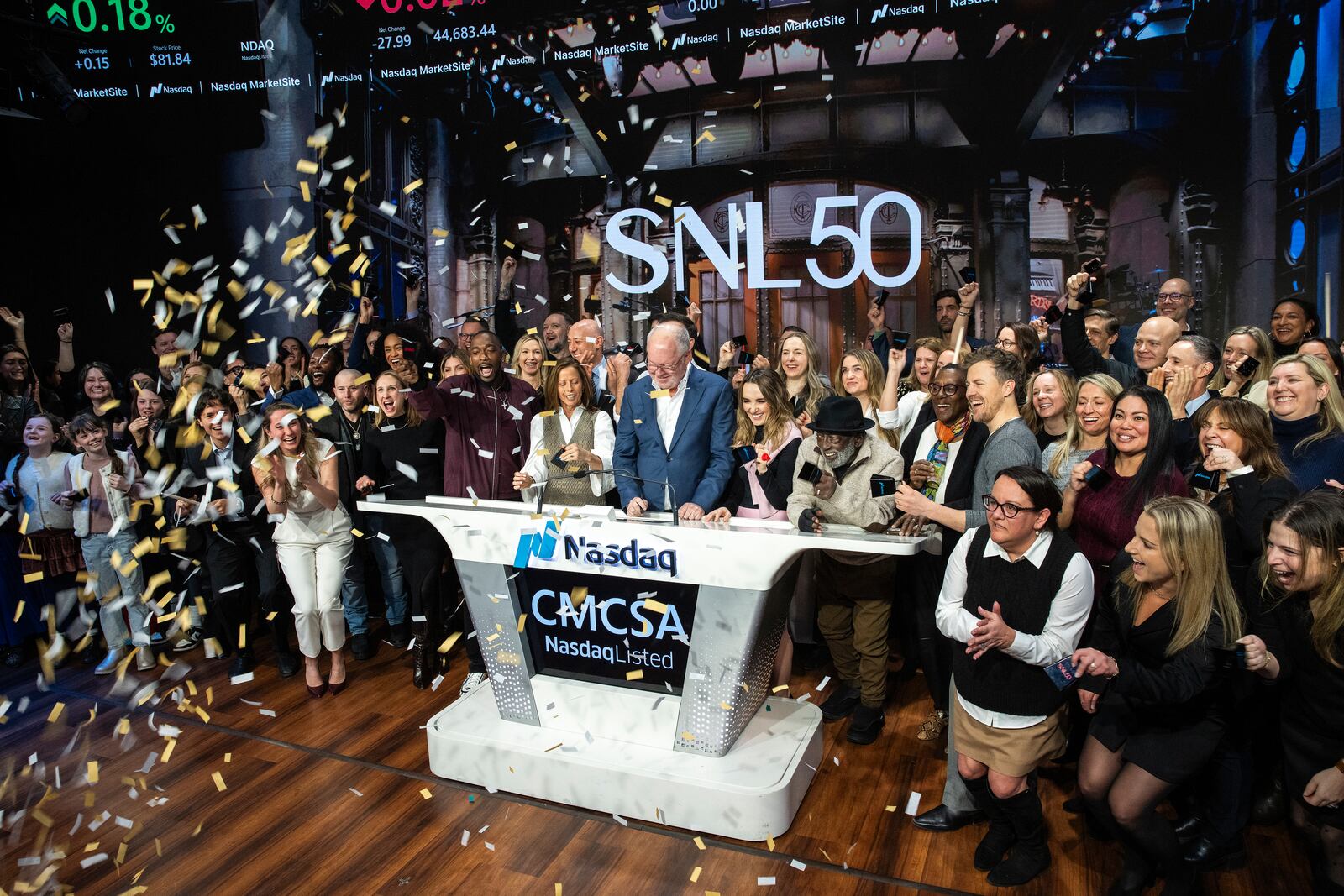 Mark Marshall, center, chairman of Global Advertising & Partnerships, NBCUniversal, and current and veteran members of the SNL cast, celebrate the SNL IPO as they ring the Nasdaq opening bell, in New York's Times Square, Friday, Feb. 14, 2025. (AP Photo/Eduardo Munoz Alvarez)