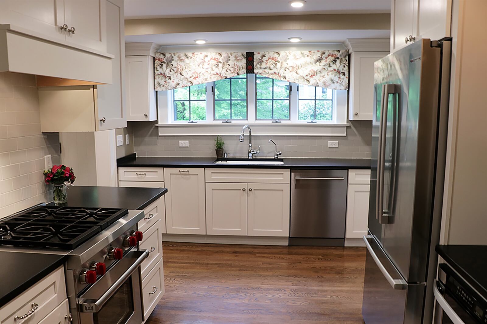 The L-shaped kitchen includes shaker cabinetry and stainless-steel appliances, including a gas stove and under-counter microwave. Brushed granite countertops wrap around corners to offer additional work space or breakfast bar seating. CONTRIBUTED PHOTO BY KATHY TYLER