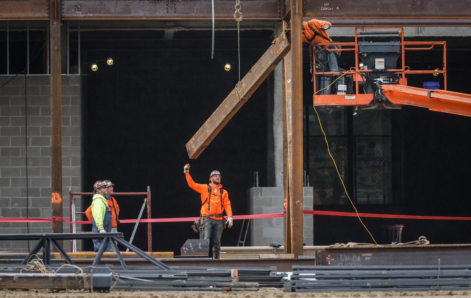 Workers hoist steel on the remodel and expansion of the Miami Valley Career Tech Center at 6800 Hoke Rd. JIM NOELKER/STAFF