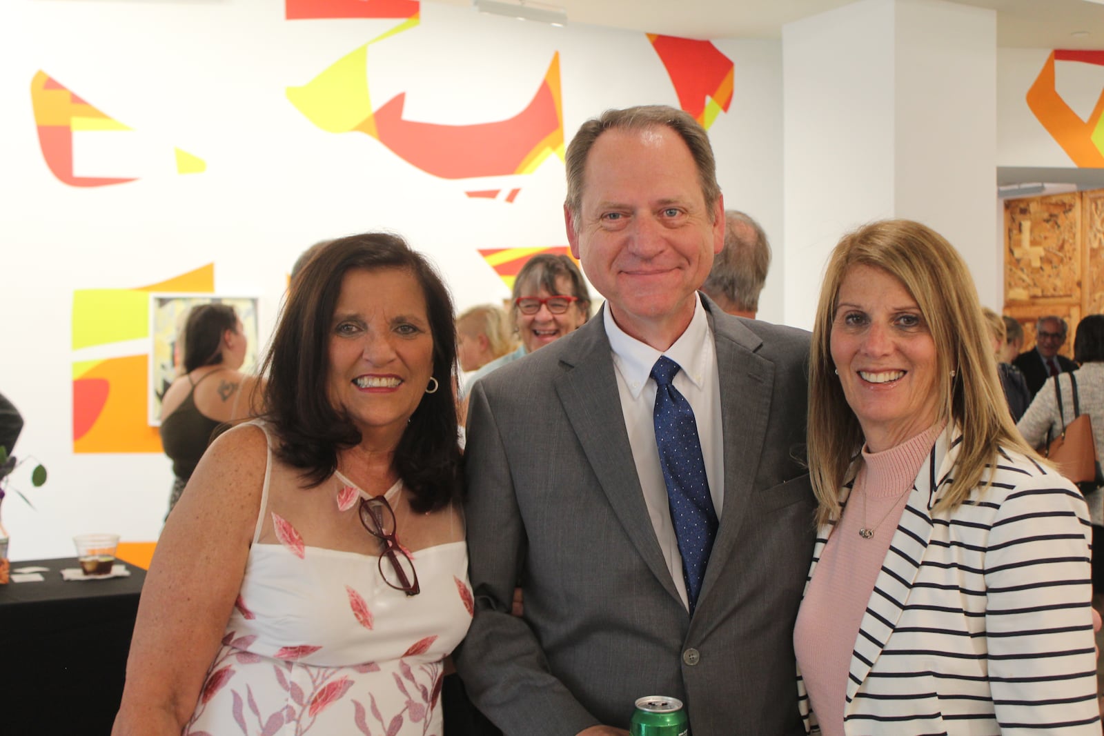 Sandy Gudorf at a retirement celebration in late June 2023 with Dan Meixner, president of Chaminade Julienne Catholic High School, and Julie Liss-Katz, consulting director for the Dayton Business Committee. CORNELIUS FROLIK / STAFF