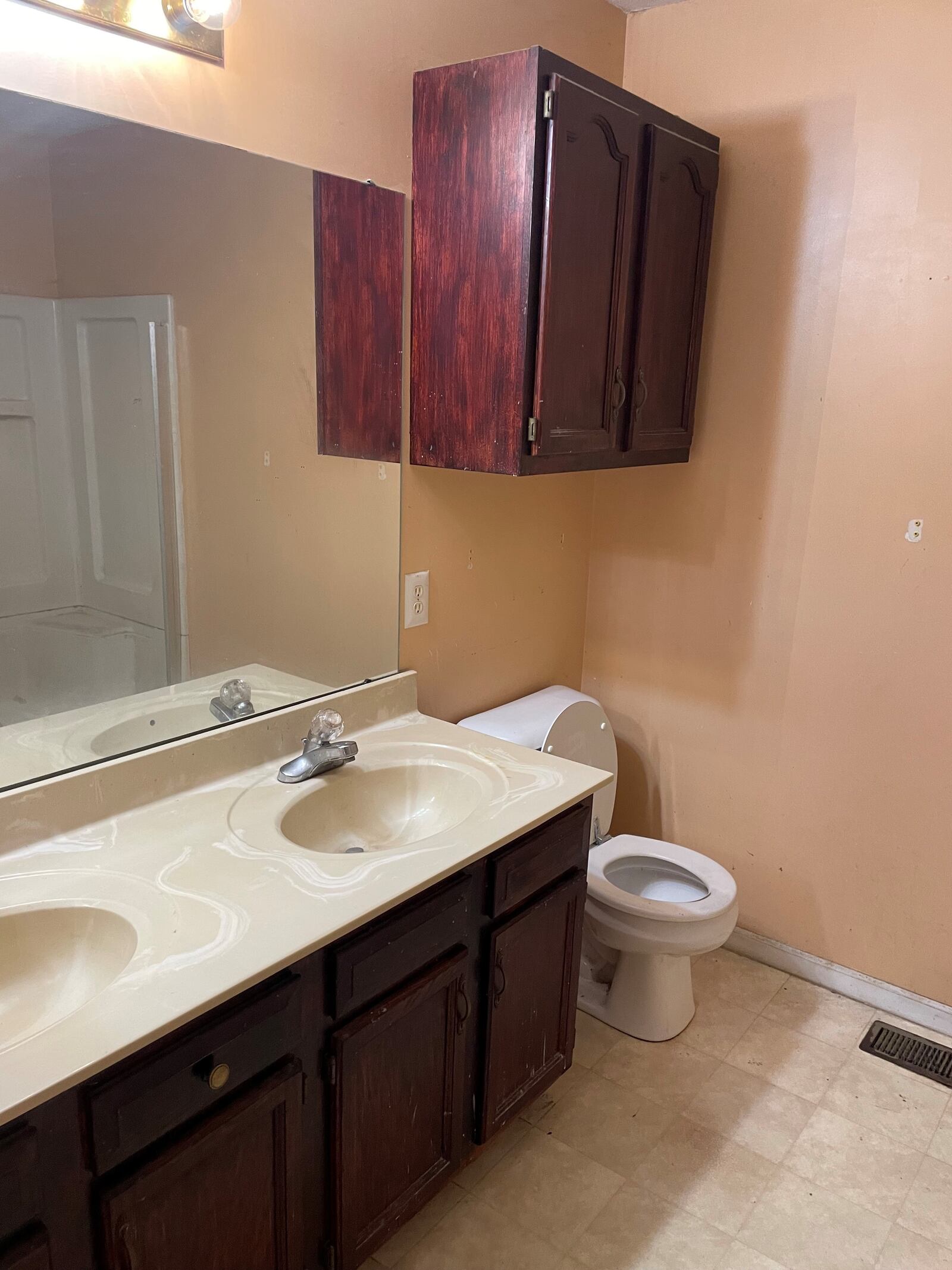 This is a "before" image of the sink and toilet in the master bathroom. Contributed by Debbie Shaw 