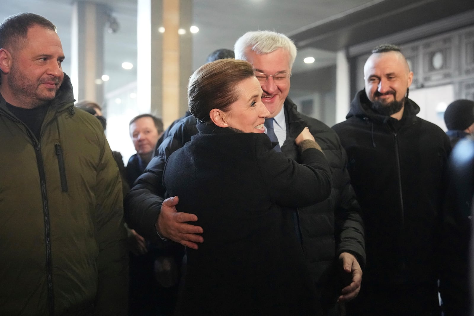 Ukraine's Foreign Minister Andriiy Sybiha, center, greets Denmark's Prime Minister Mette Frederiksen at a train station in Kyiv, Ukraine, Monday, Feb. 24, 2025. (AP Photo/Efrem Lukatsky)