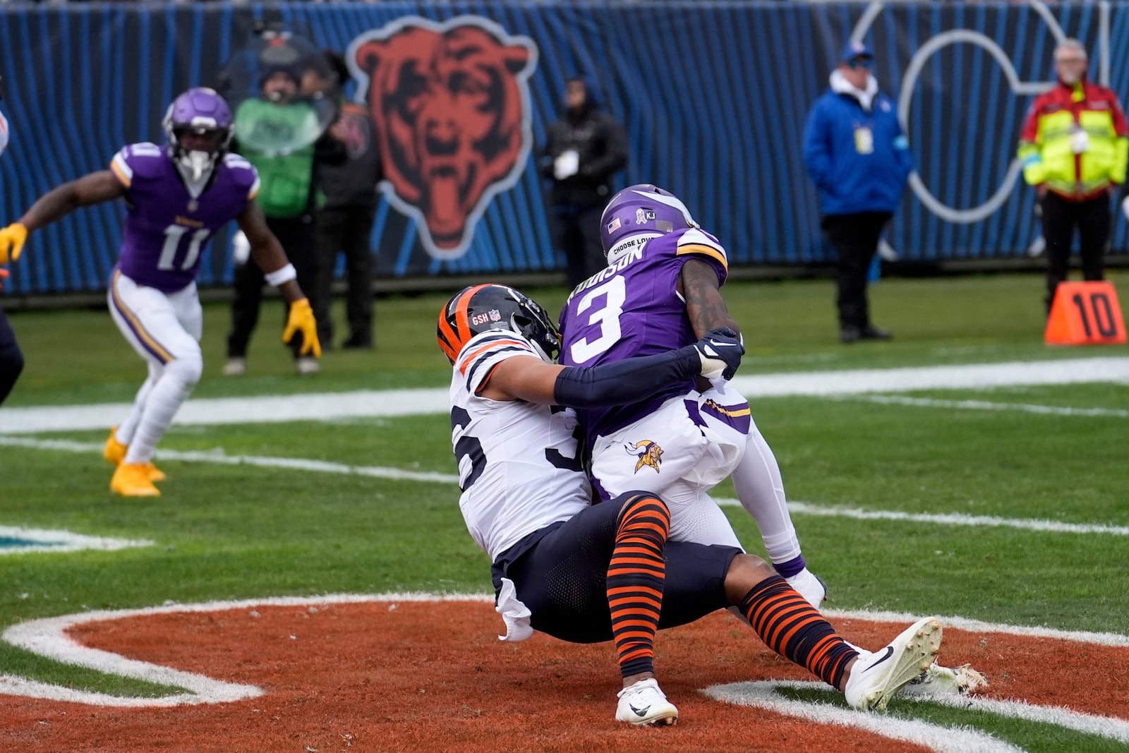 Minnesota Vikings wide receiver Jordan Addison (3) makes a touchdown catch as Chicago Bears safety Jonathan Owens tackles during the first half of an NFL football game Sunday, Nov. 24, 2024, in Chicago. (AP Photo/Charles Rex Arbogast)