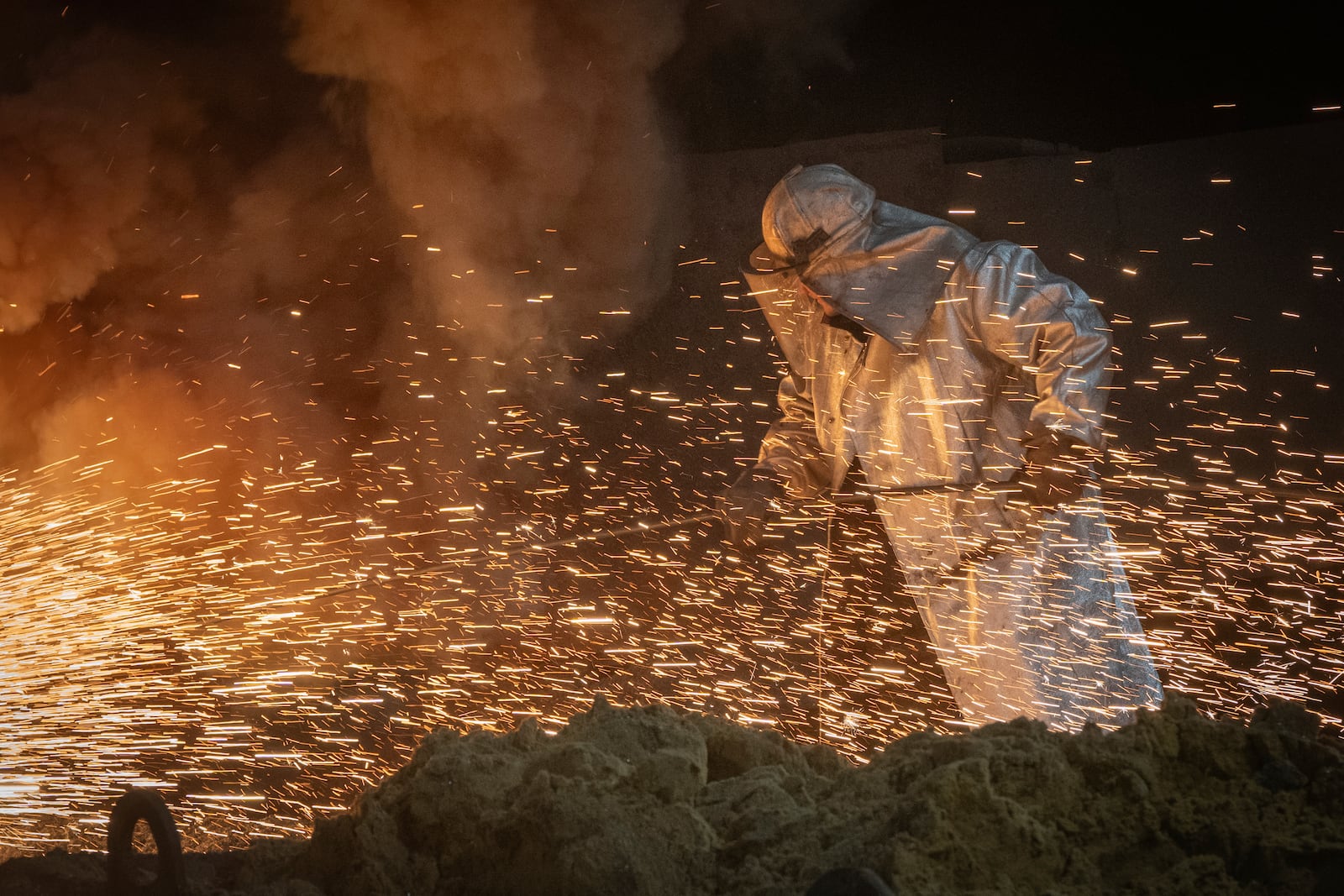 A worker in protective clothes melts steel at the Zaporizhstal Iron and Steelworks, one of the country's largest steel plants, in Zaporizhzhia, Ukraine, Thursday, Feb. 13, 2025. (AP Photo/Efrem Lukatsky)