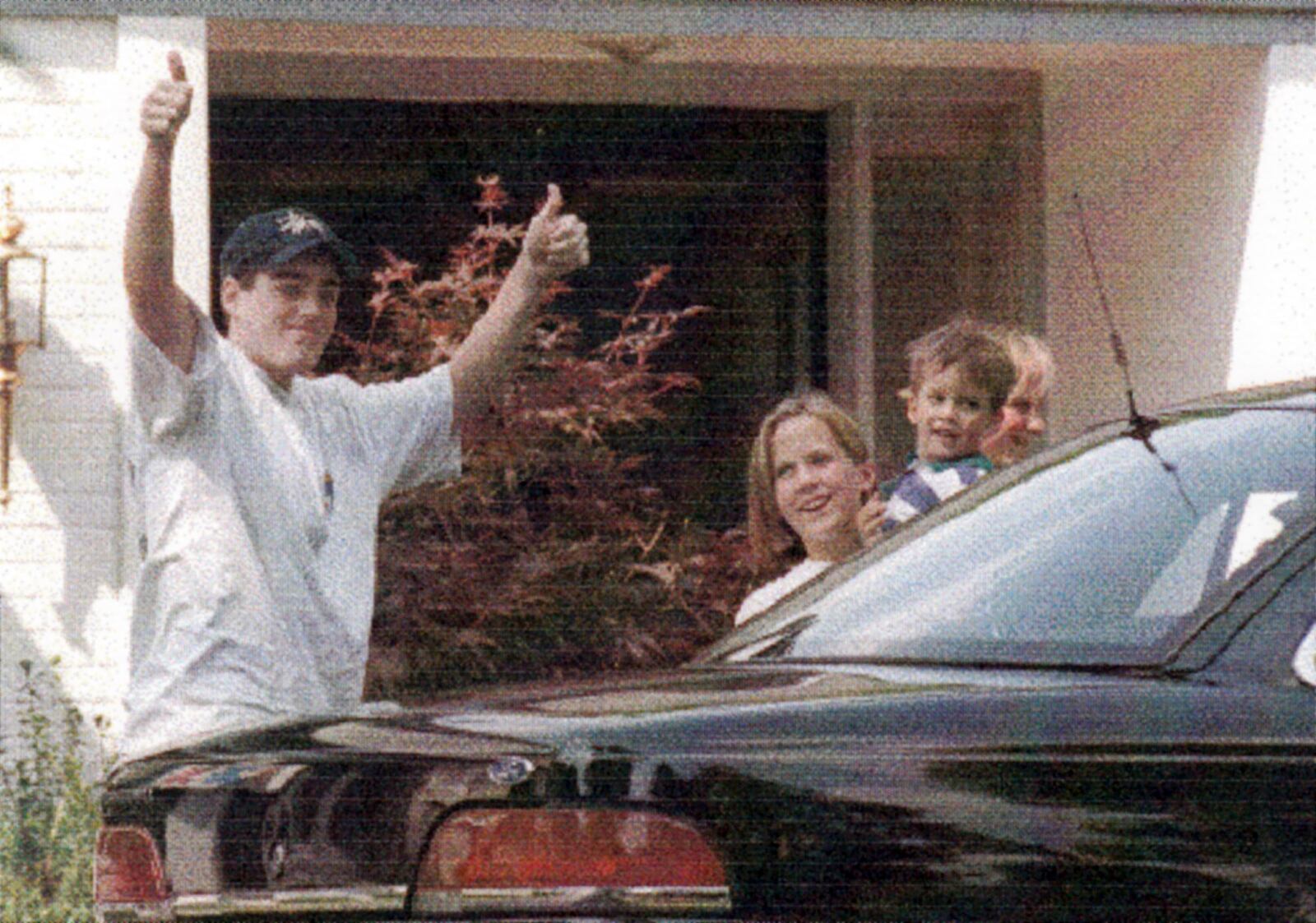 June 22, 1994  Michael Fay gives the crowd and media a thumbs up after arriving at his Kettering home after being caned in Singapore.  To the right is neighbor Liz Brown holding his 3-year-old stepbrother Chris.  SKIP PETERSON / STAFF / FILE