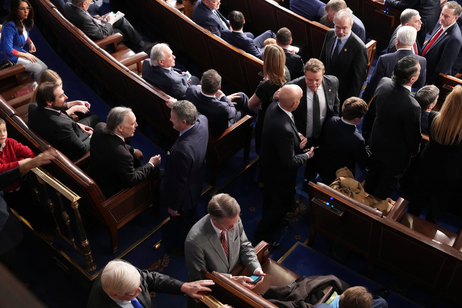 Members of the Freedom Caucus gather at the back of the room during the roll call as the House of Representatives meets to elect a speaker and convene the new 119th Congress at the Capitol in Washington, Friday, Jan. 3, 2025. (AP Photo/Jacquelyn Martin)