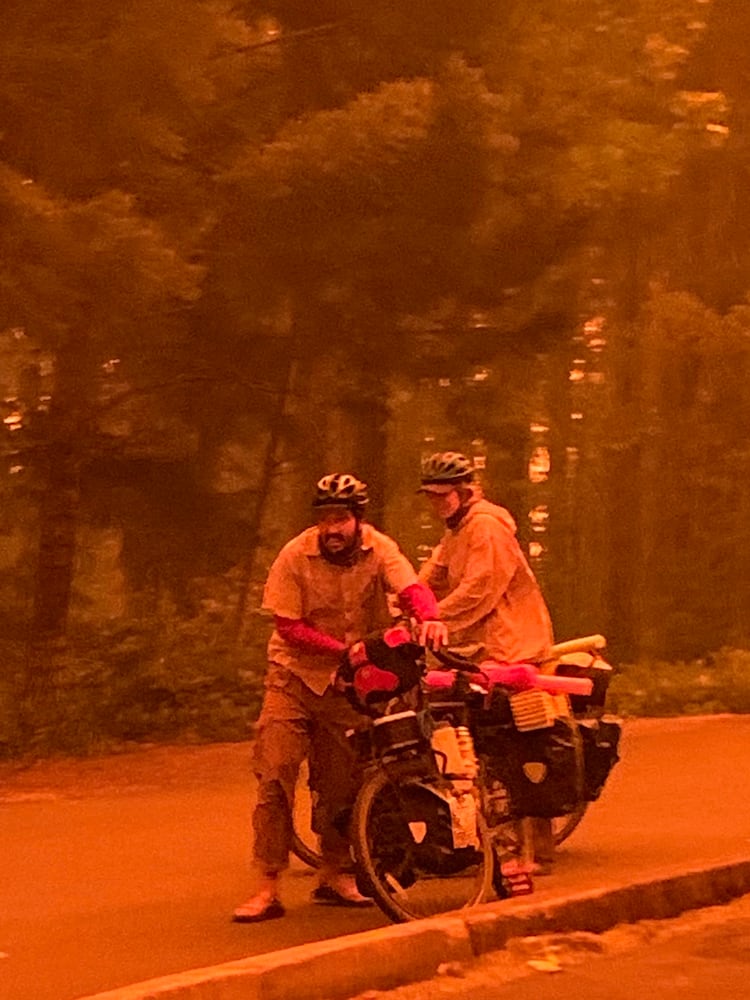 *EMBARGO: No electronic distribution, Web posting or street sales before THURSDAY 3:01 a.m. ET SEPT. 17, 2020. No exceptions for any reasons. EMBARGO set by source.**An image provided by Cindy Neblett, two evacuees arrived by bike amidst the fire in Detroit, Ore. After raging wildfires left them trapped on the shores of a reservoir near Detroit, Ore., dozens of people and nine firefighters mounted a last stand, hoping for a miracle. (Cindy Neblett via The New York Times)-- NO SALES; FOR EDITORIAL USE ONLY WITH NYT STORY ORE-WILDFIRES-ESCAPE BY JACK HEALY AND MIKE BAKER FOR SEPT. 16, 2020. ALL OTHER USE PROHIBITED. --