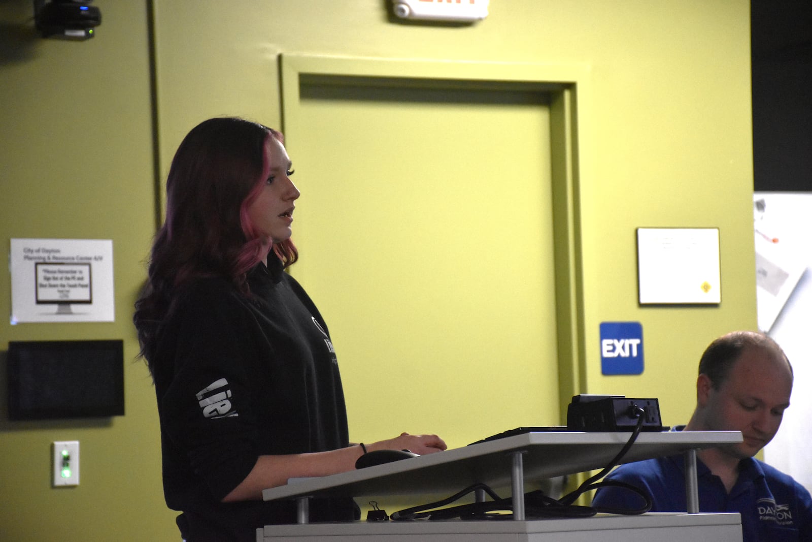 Mackenzie Johns, a former Liberty High School student and current staff member, speaks at a Dayton Board of Zoning Appeals meeting in late February 2024. CORNELIUS FROLIK / STAFF