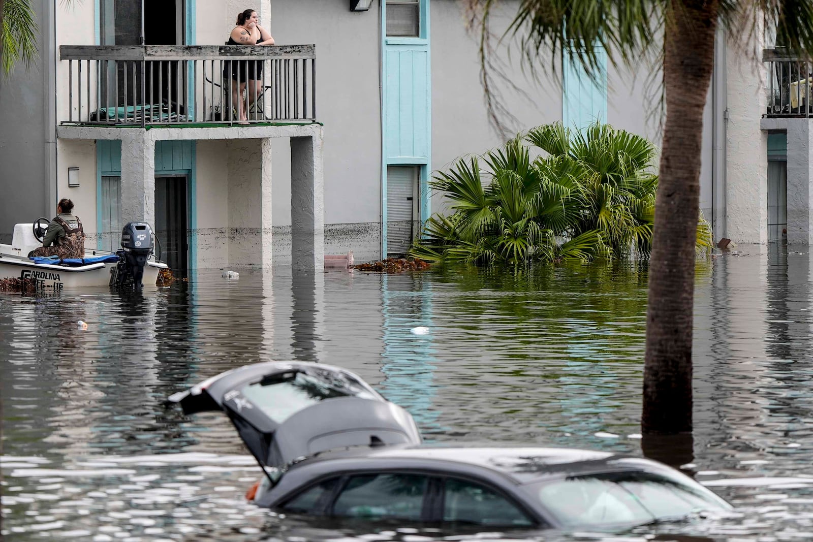 People await being rescued from an apartment complex in the aftermath of Hurricane Milton, Thursday, Oct. 10, 2024, in Clearwater, Fla. (AP Photo/Mike Stewart)