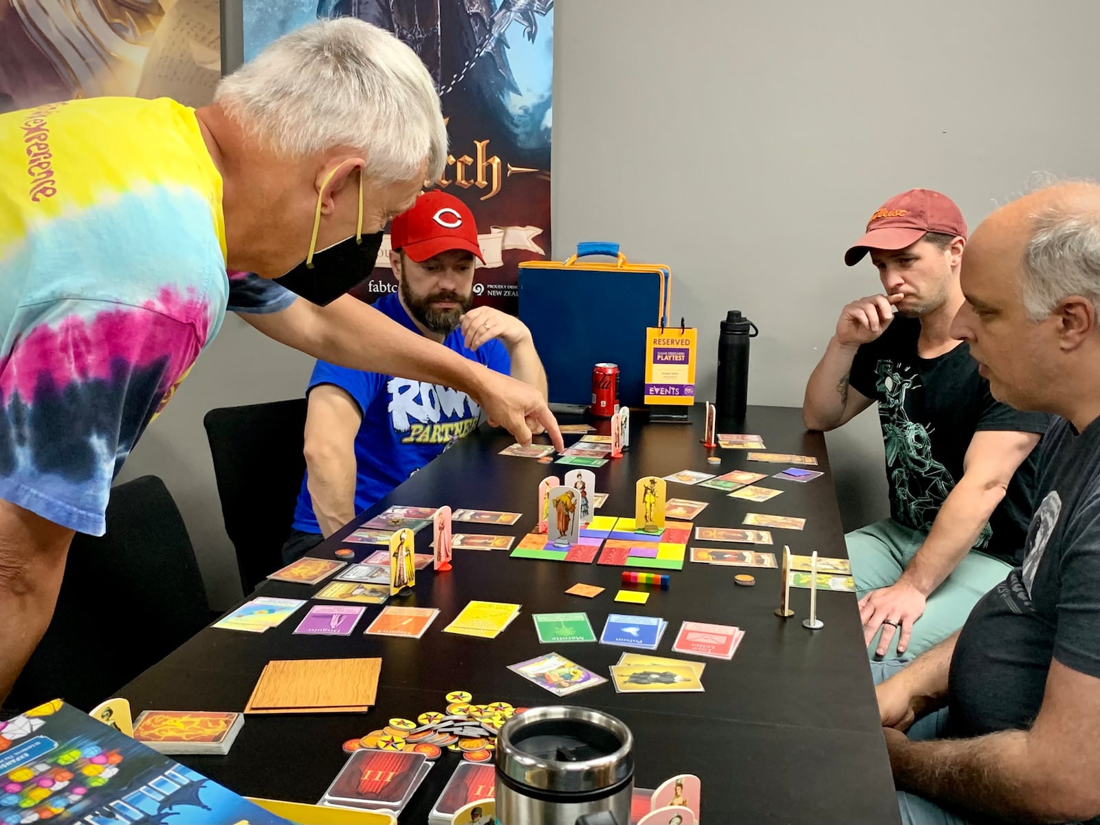 Jeffrey Secrest (left) teaches his game, Upstaged!, to a group of playtesters at Epic Loot in Centerville, on Sunday, July 9.  LONDON BISHOP/STAFF