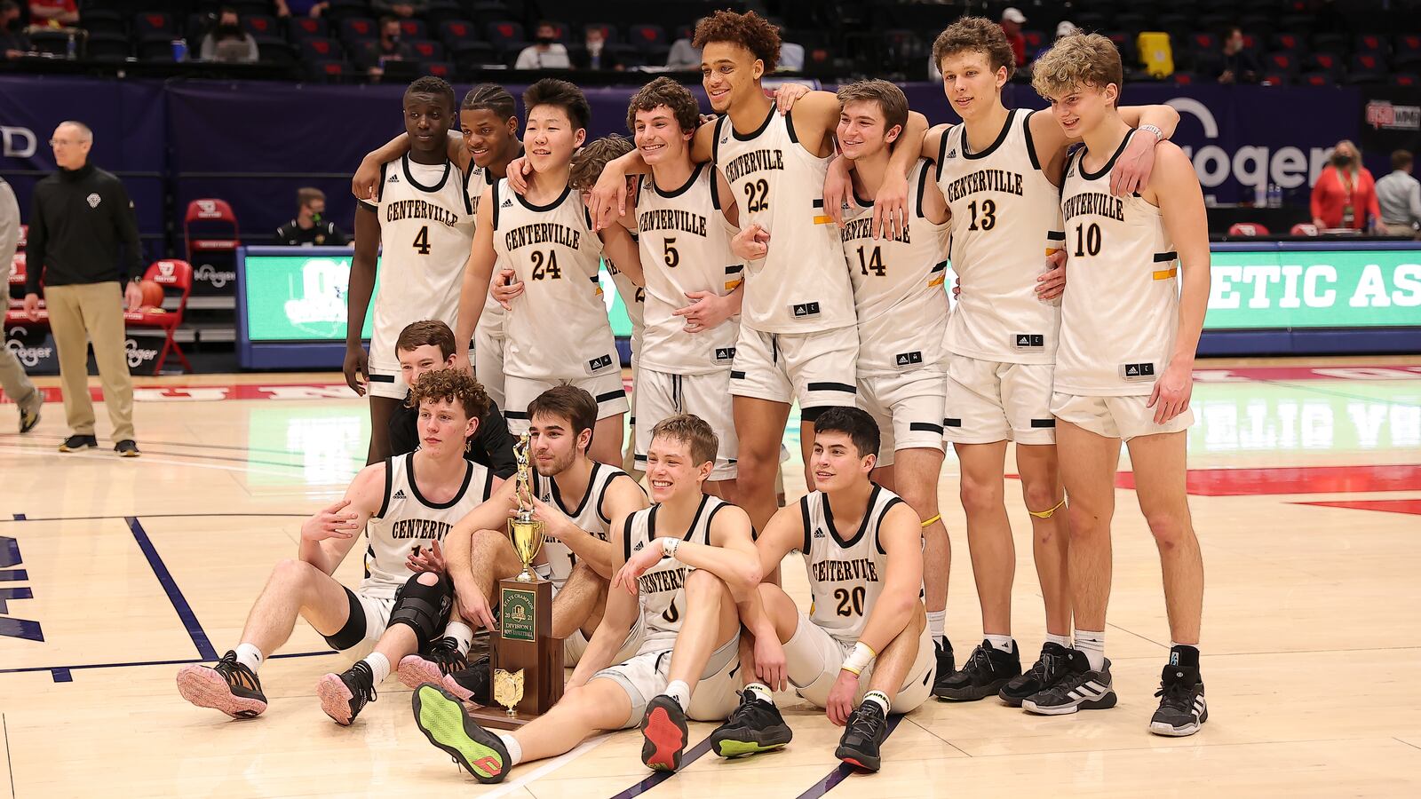 The Centerville Elks boys basketball team pose for a photo with the Division I state championship trophy on Sunday night at UD Arena. The Elks defeated Westerville Central 43-42 in the title game. Michael Cooper/CONTRIBUTED