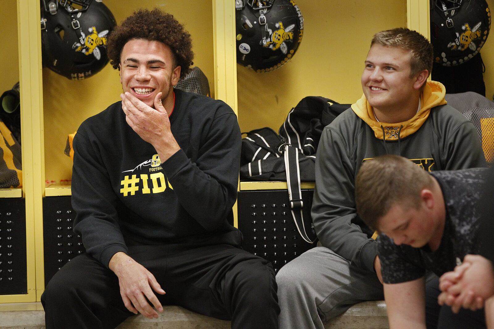 Sidney High School senior running back Isaiah Bowser (left) is one of the front runners for Ohio’s Mr. Football. As a child, Bowser was abused by his mother’s boyfriend who burned Bowser’s hands in scalding water and ended up imprisoned because of it. TY GREENLEES / STAFF