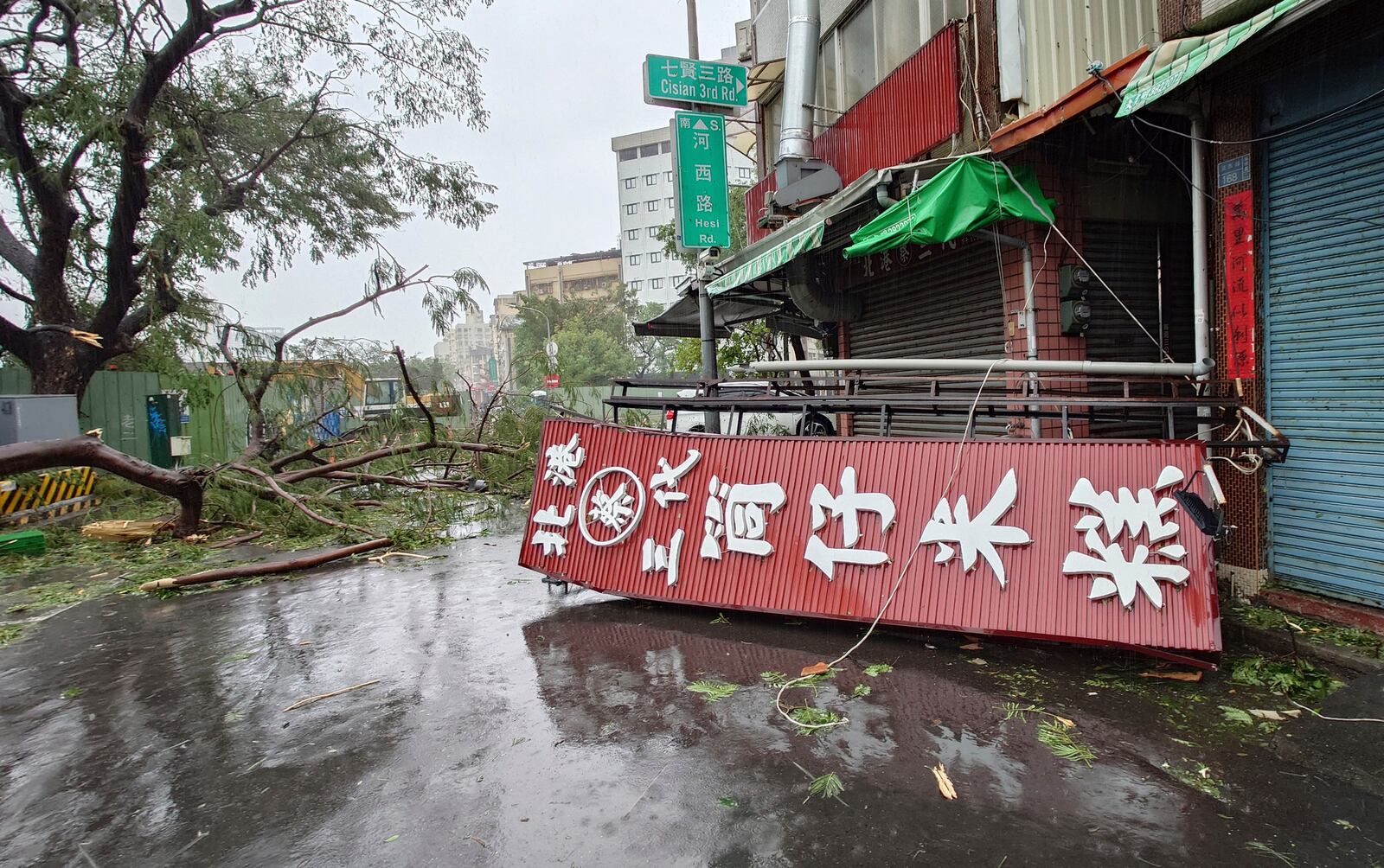 A fallen signage lies on the pavement as as Typhoon Krathon makes landfall in Kaohsiung, southern Taiwan, Thursday, Oct. 3, 2024. (AP Photo/Chiang Ying-ying)