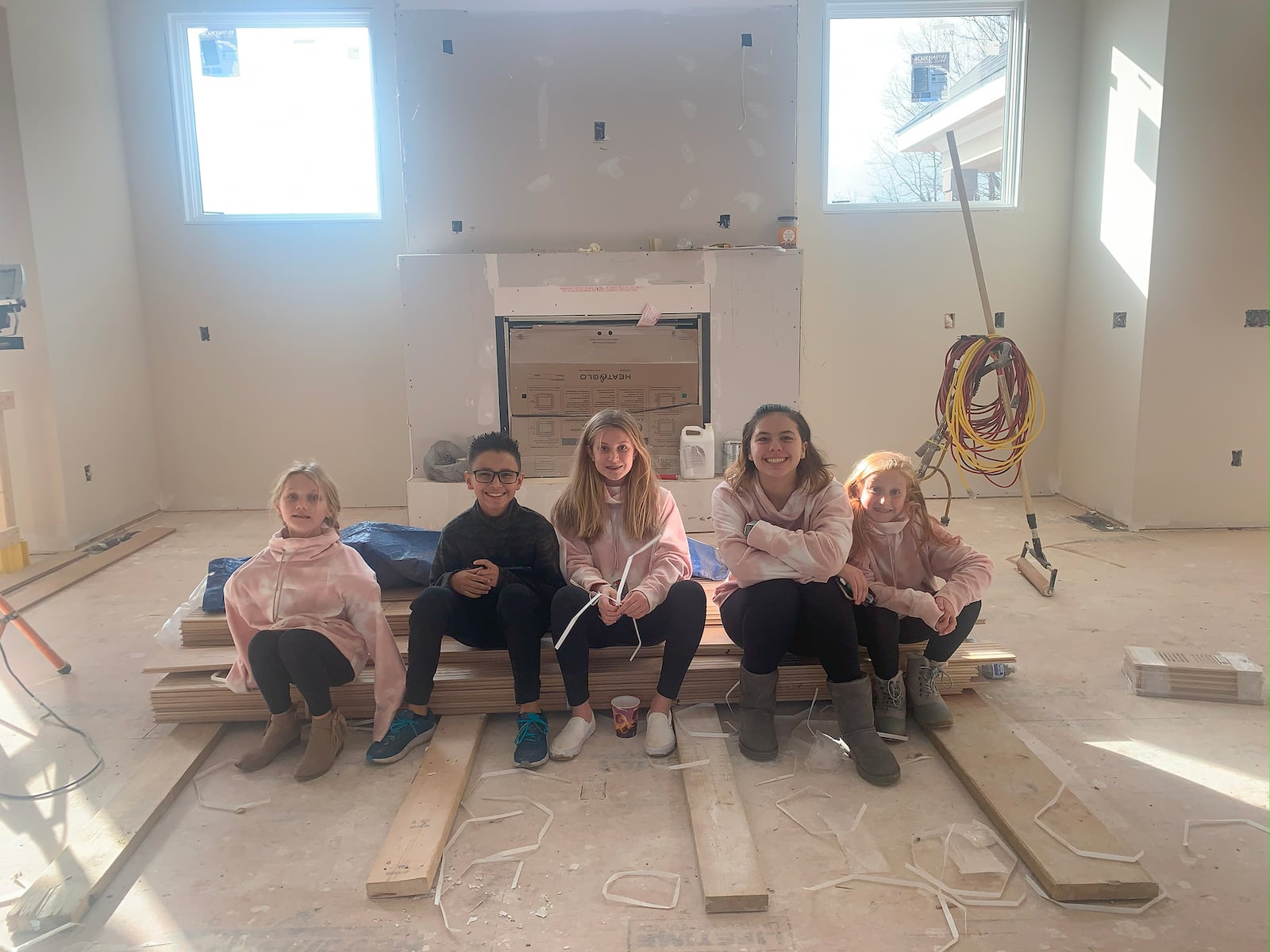 Vicki and Ed's grandchildren, Charlotte (Charlie), Greg, Izzi, Alana and Stella, "inspect" the great room fireplace in the home while it was under construction.