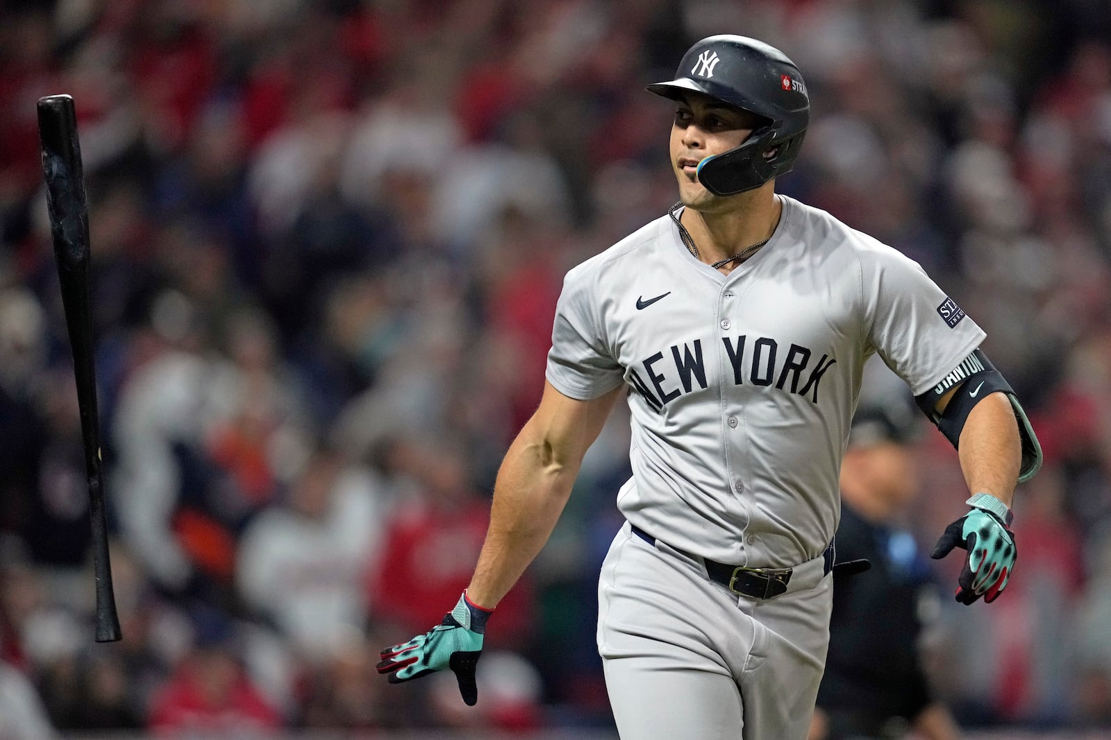 New York Yankees' Giancarlo Stanton tosses his bat after hitting a three-run home run against the Cleveland Guardians during the sixth inning in Game 4 of the baseball AL Championship Series Friday, Oct. 18, 2024, in Cleveland. (AP Photo/Godofredo A. Vásquez)