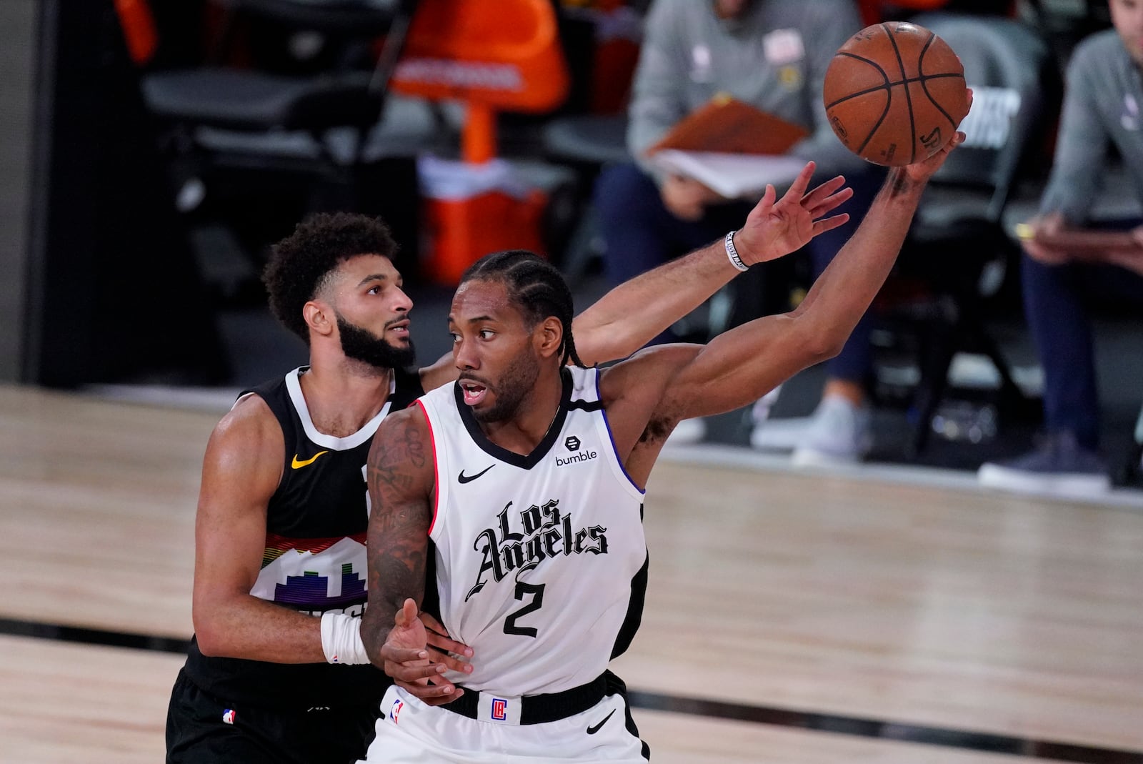 Los Angeles Clippers' Kawhi Leonard (2) is defended by Denver Nuggets' Jamal Murray (27) during the second half of an NBA conference semifinal playoff basketball game, Wednesday, Sept. 9, 2020, in Lake Buena Vista, Fla. (AP Photo/Mark J. Terrill)