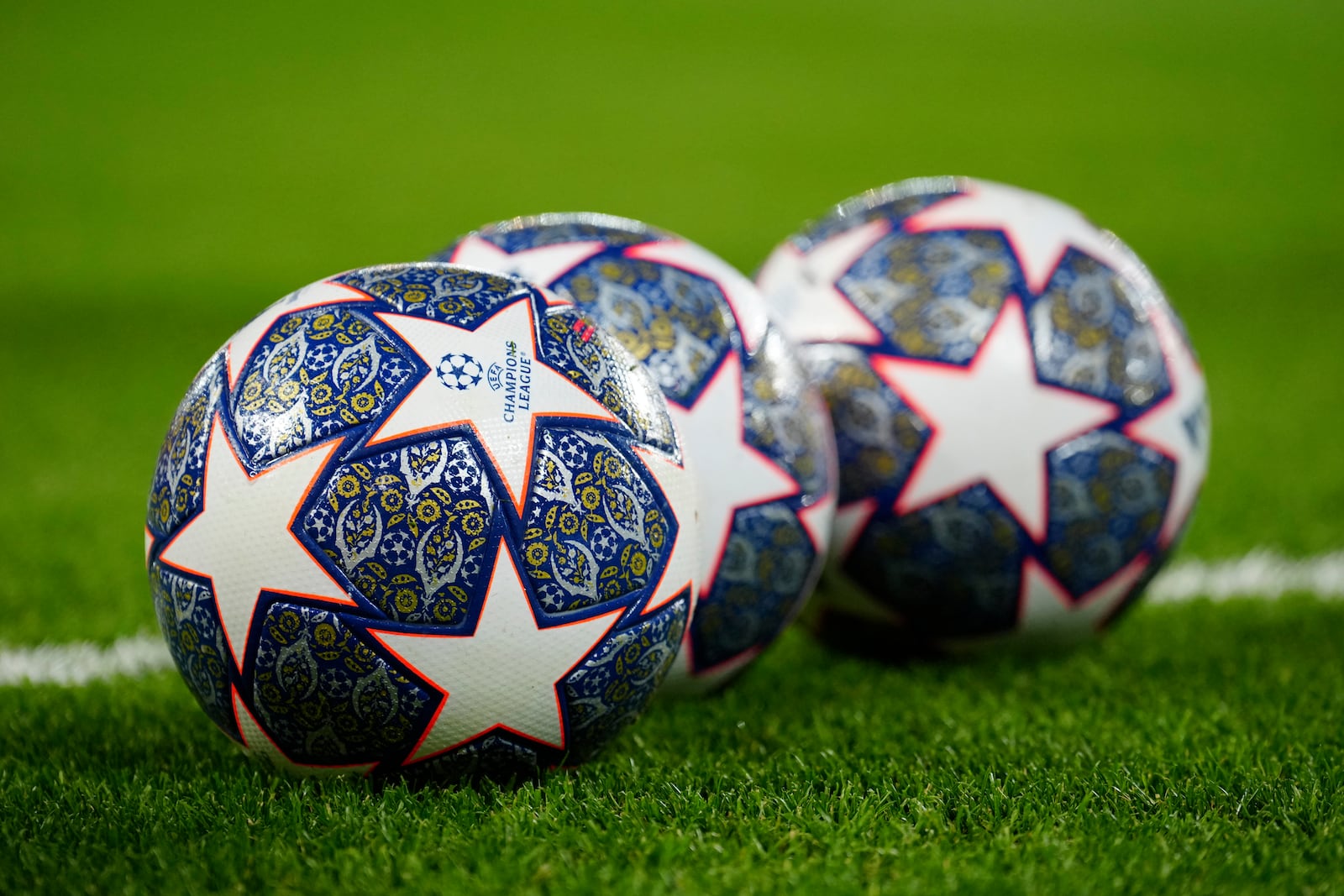 The Official UEFA Champions League match balls lie on the pitch ahead of the Champions League, round of 16, first leg soccer match between Liverpool and Real Madrid at the Anfield stadium in Liverpool, England, on Feb. 21, 2023. (AP Photo/Jon Super, File)