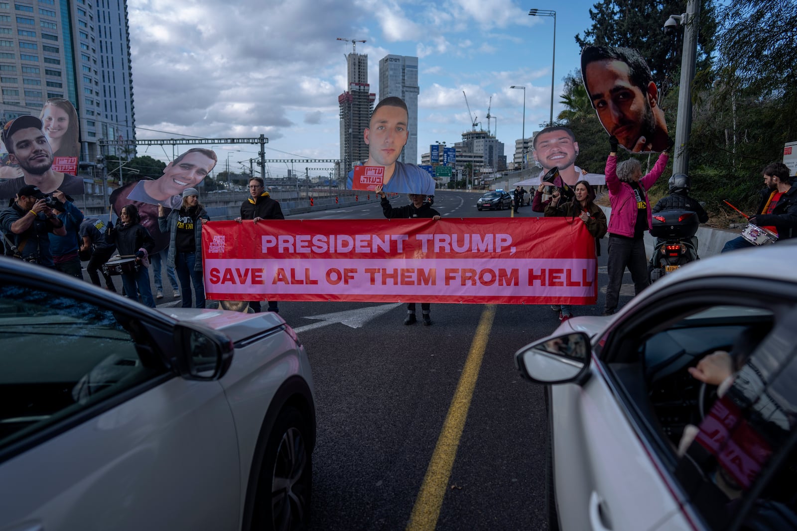 Relatives and supporters of Israelis held hostage in the Gaza Strip, block a higway during a protest demanding their release from Hamas captivity, in Tel Aviv, Israel, Thursday, Feb. 13, 2025. (AP Photo/Oded Balilty)