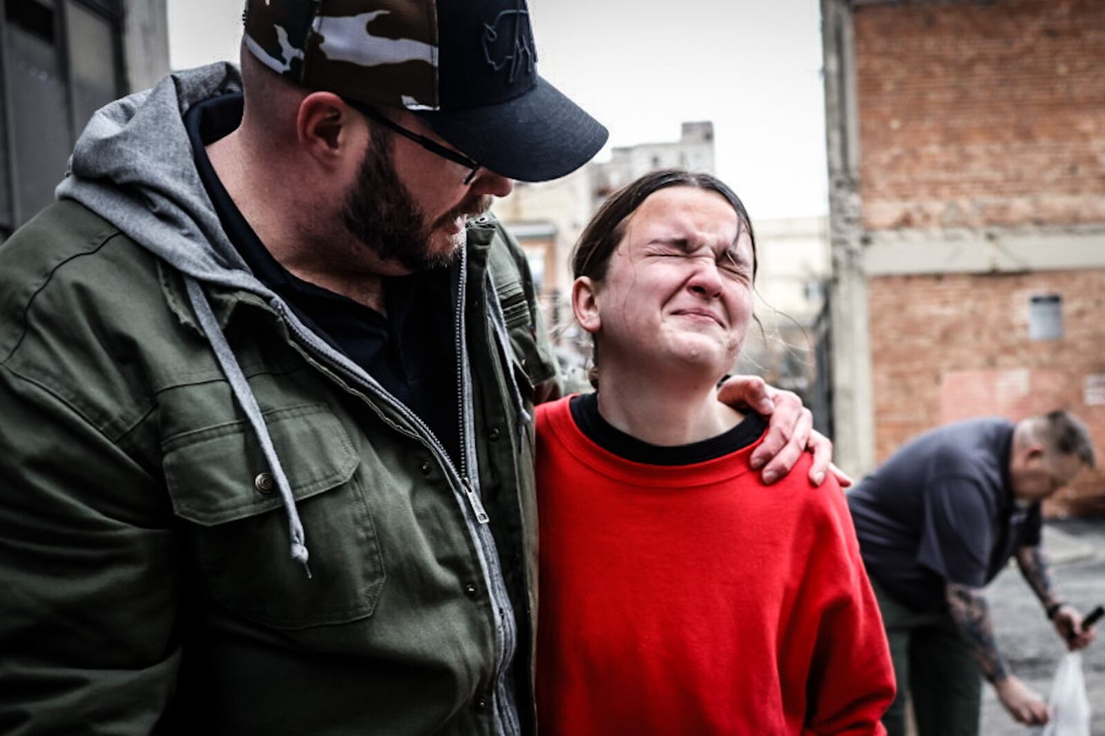 Sinclair Collage police academy instructor Shaun Fleming, left helps cadet Katie Wise after Wise was sprayed with pepper spray. Students were exposed to the chemical to get an idea what it was like being sprayed.  JIM NOELKER/STAFF