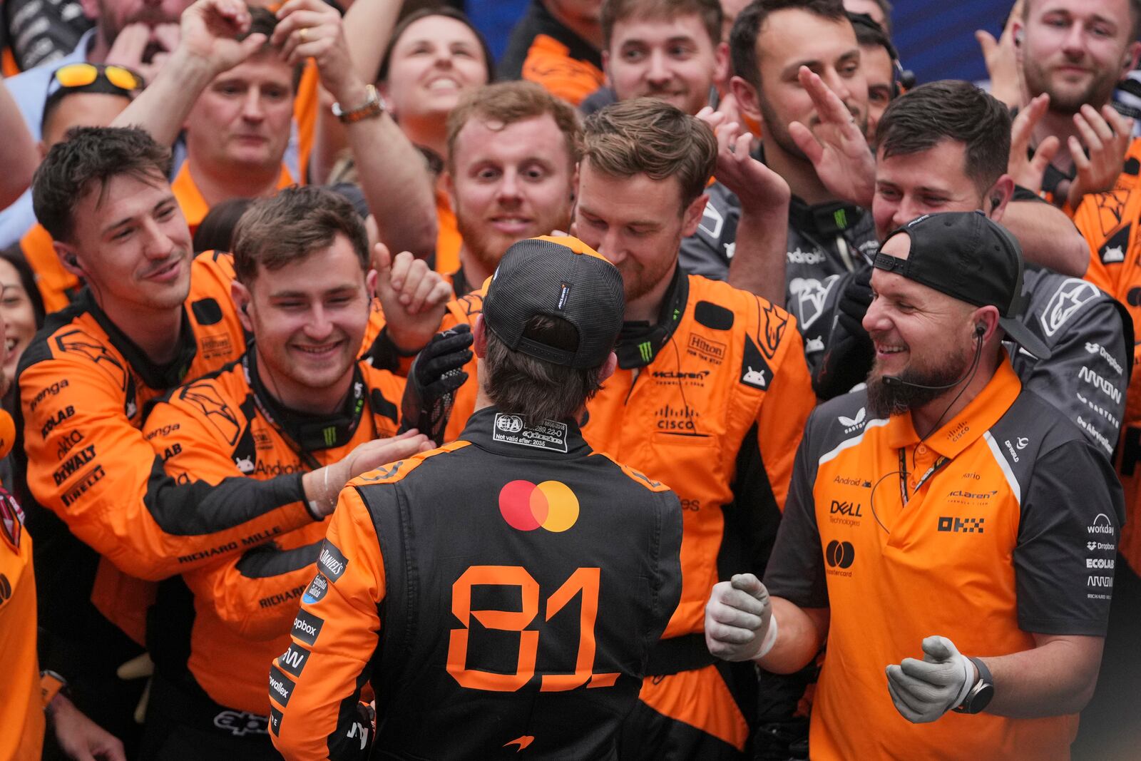 McLaren driver Oscar Piastri of Australia, centre, celebrates with his team after winning the Chinese Formula One Grand Prix race at the Shanghai International Circuit, Shanghai, Sunday, March 23, 2025. (AP Photo/Andy Wong)