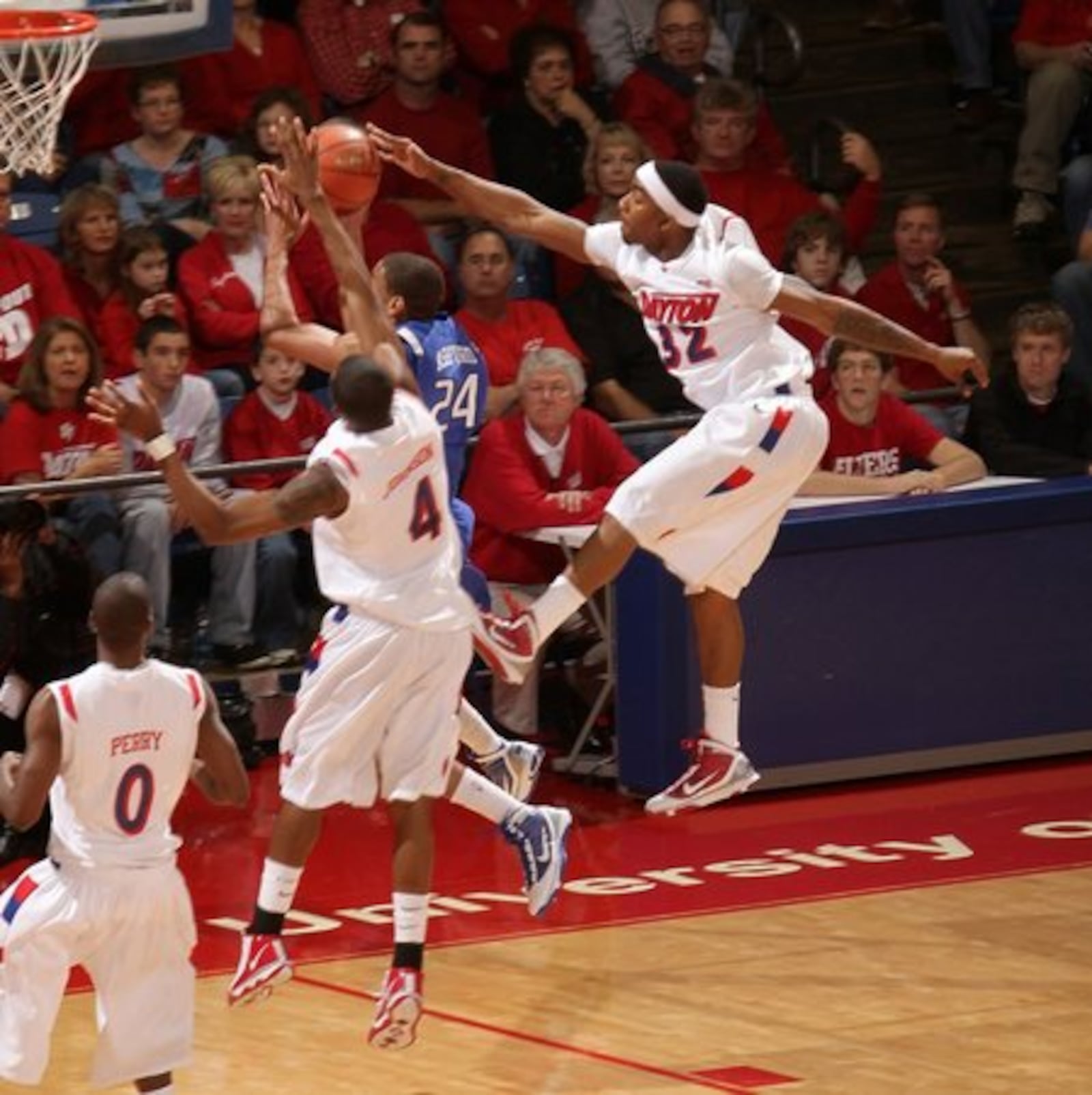 Dayton's Marcus Johnson (32) and Chris Johnson (4) team up to block a shot by Creighton's Darryl Ashford.The Flyers won their season opener 90-80 against Creighton on Saturday, November 14, 2009.