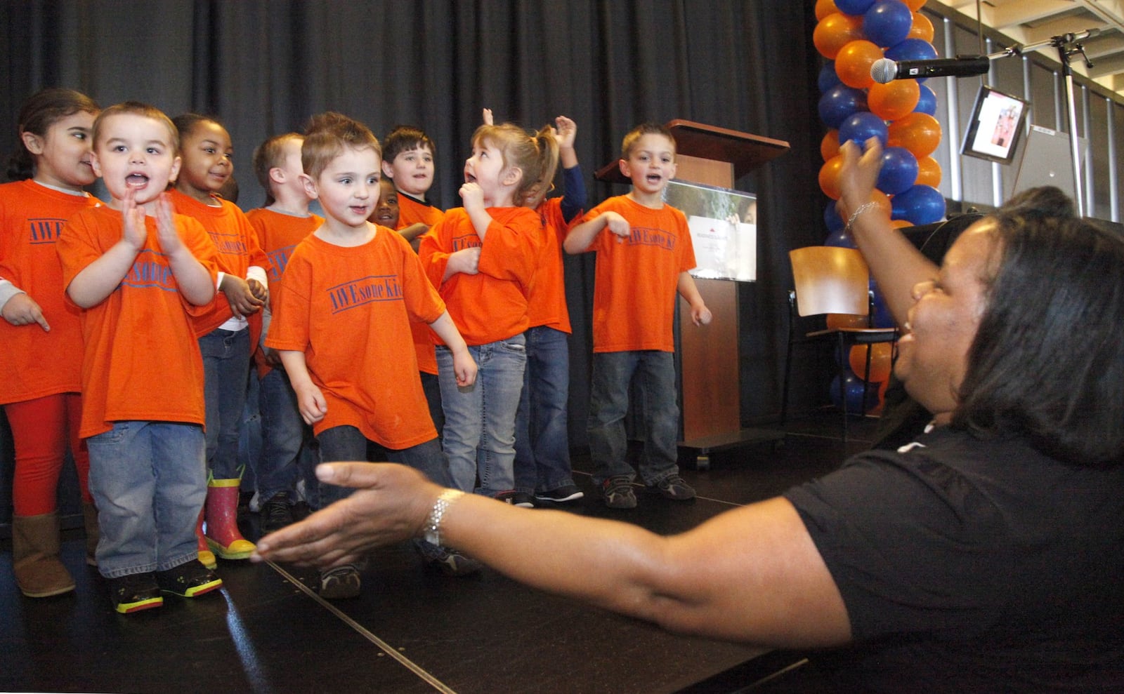 The area’s fifth annual Kindergarten Readiness Summit was held Friday at Sinclair Community College. More than 500 educators heard updates from Senate Education Committee Chair Peggy Lehner and others. Madonna Gayles (right), the lead teacher at Miami Valley Child Development Center, lead students in the Passport to Kindergarten program in a song during the event. LISA POWELL / STAFF