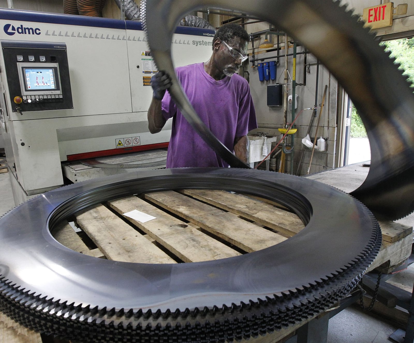 Thearon Moore operates a deburring machine at Staub Manufacturing Solutions in Dayton. TY GREENLEES / STAFF