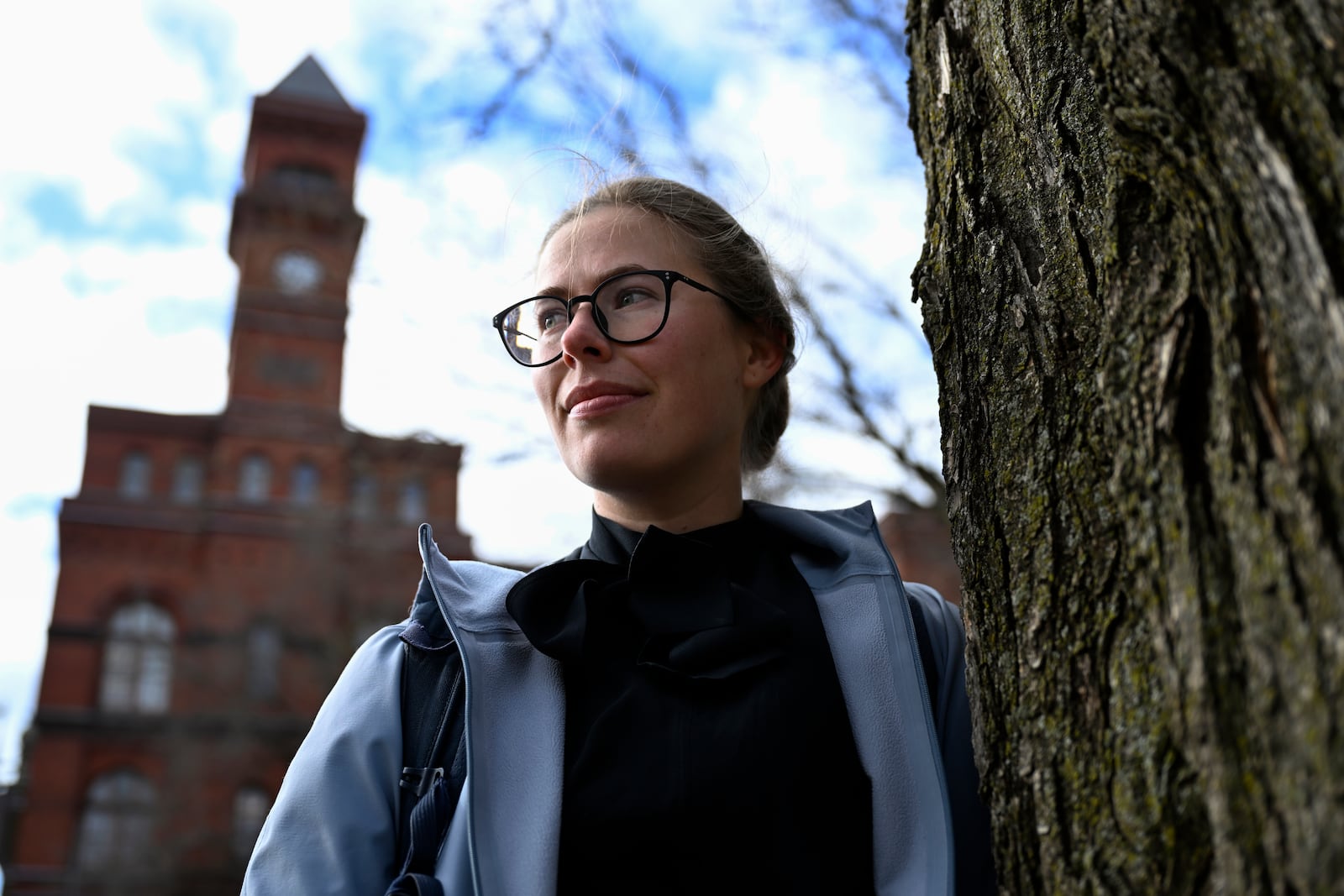 Sydney Smith, who lost her job due to DOGE cuts, stands in front of the Sydney Yates building that houses the Forest Service on Thursday, March. 6, 2025, in Washington. (AP Photo/John McDonnell)