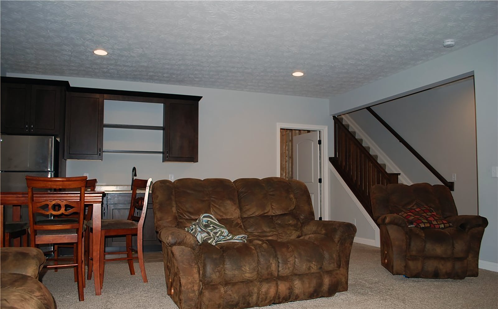 The finished basement has a kitchenette and recreation room with carpeting.