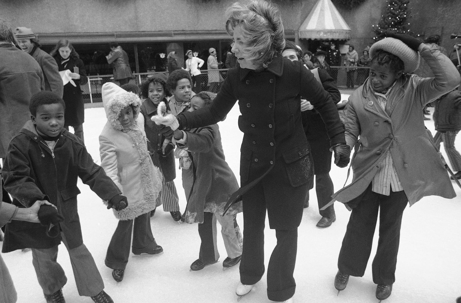 FILE - Ethel Kennedy, widow of Sen. Robert Kennedy, ice skates with youngsters from Bedford Stuyvesant, Brooklyn borough, at the eighth annual Kennedy skating party originated by the late senator at Rockefeller Center's skating rink on Dec. 16, 1972, in New York. (AP Photo, File)