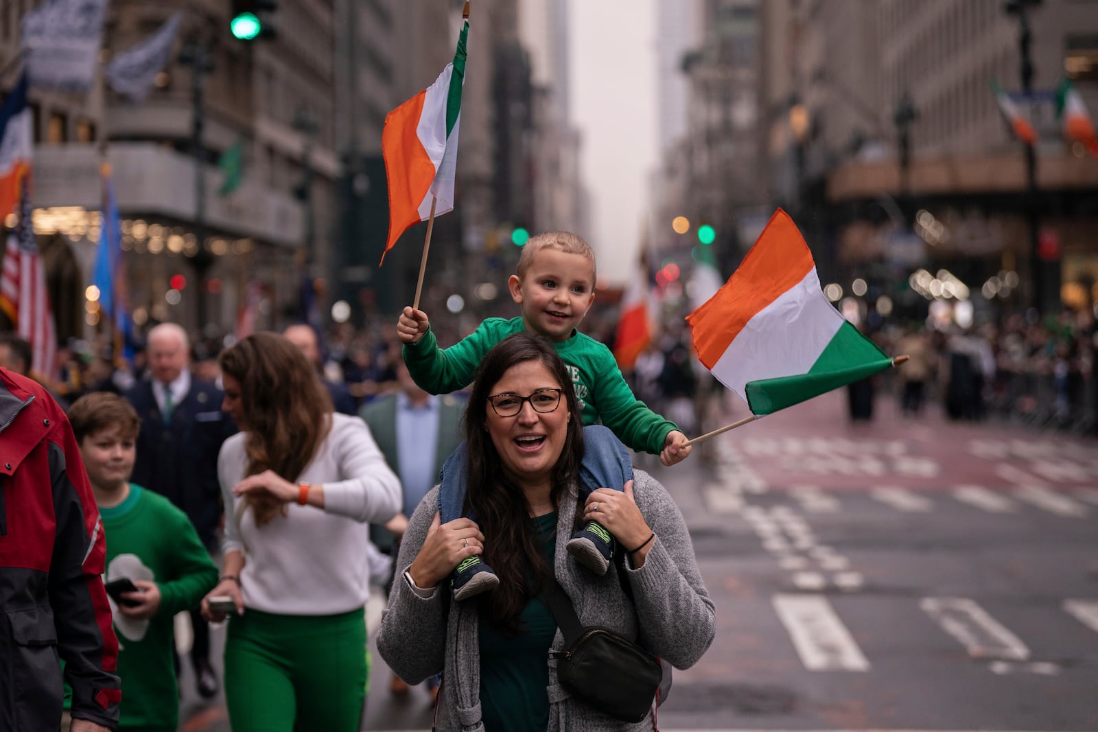 Cameron Brown, 3, waves Irish flags as he sits on the shoulders of his mother Amanda Brown, 40, at the 264th New York City Saint Patrick's Day Parade, Monday, March 17, 2025 in New York. (AP Photo/Adam Gray)