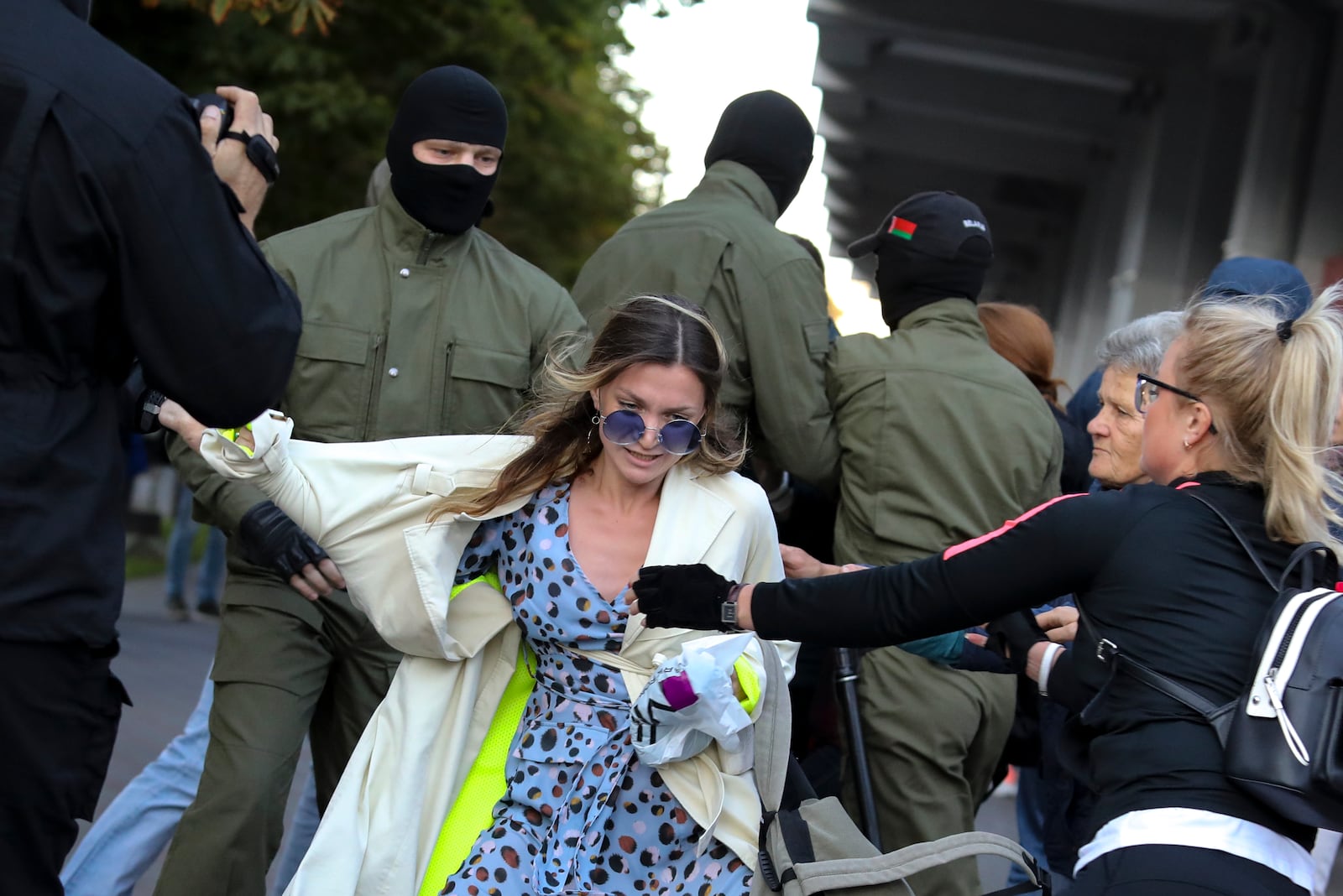 Protesters try to prevent police from detaining a demonstrator, center, during a rally in support of Maria Kolesnikova, and other members of the Coordination Council created by the opposition to facilitate talks with Lukashenko on a transition of power, was detained Monday in the capital of Minsk with two other council members, in Minsk, Belarus, Wednesday, Sept. 9, 2020. The leading opposition candidate in Belarus' disputed presidential election said Wednesday that the political tension in her country should be solved internally, by the Belarusian people, but she did not exclude the need for future international mediation. (AP Photo)