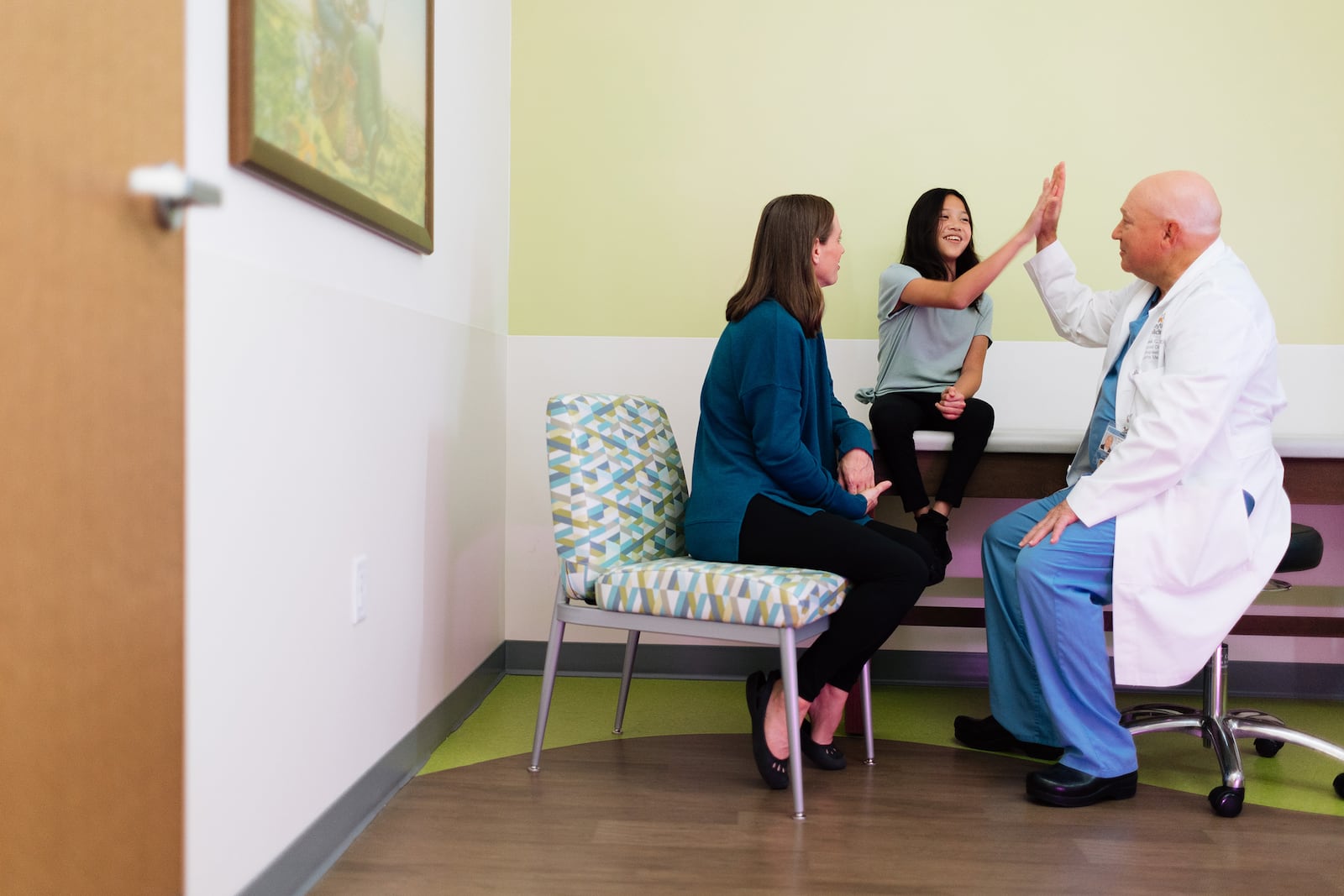 Dr. Albert with spinal fusion patient, Talley, and her mom, Mandi