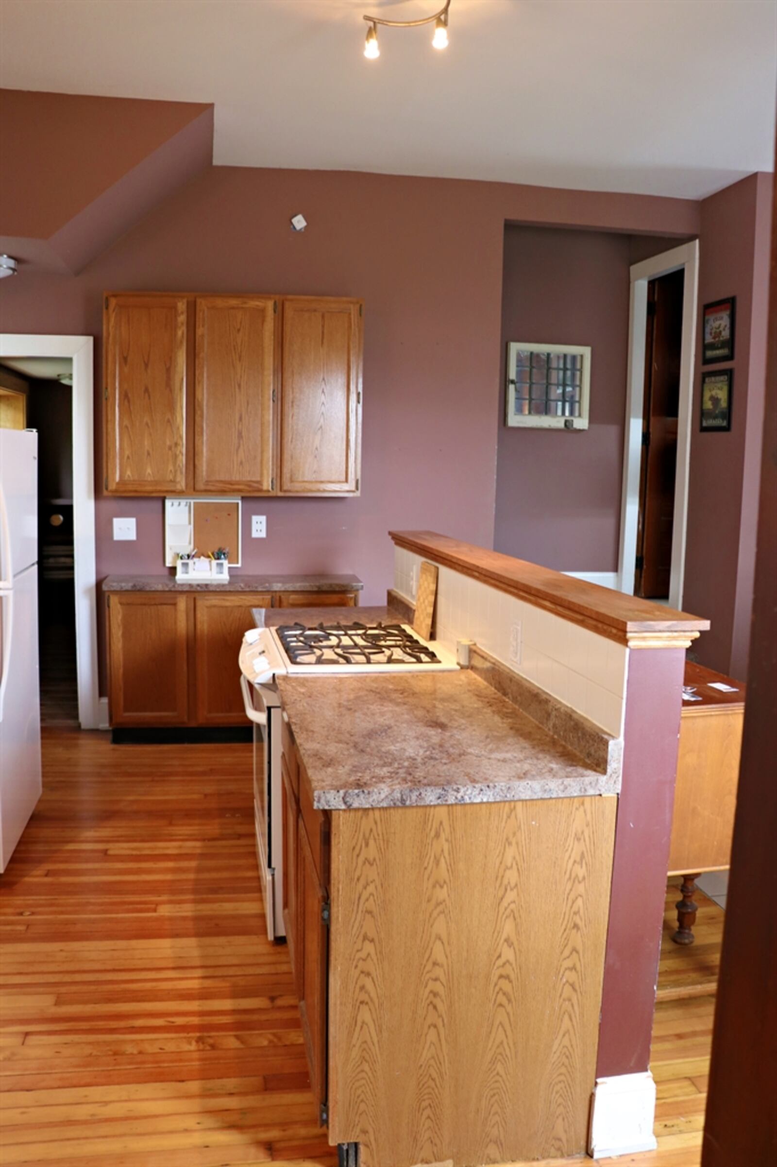 An island divides the dining room from the kitchen and provides additional storage and counter space.