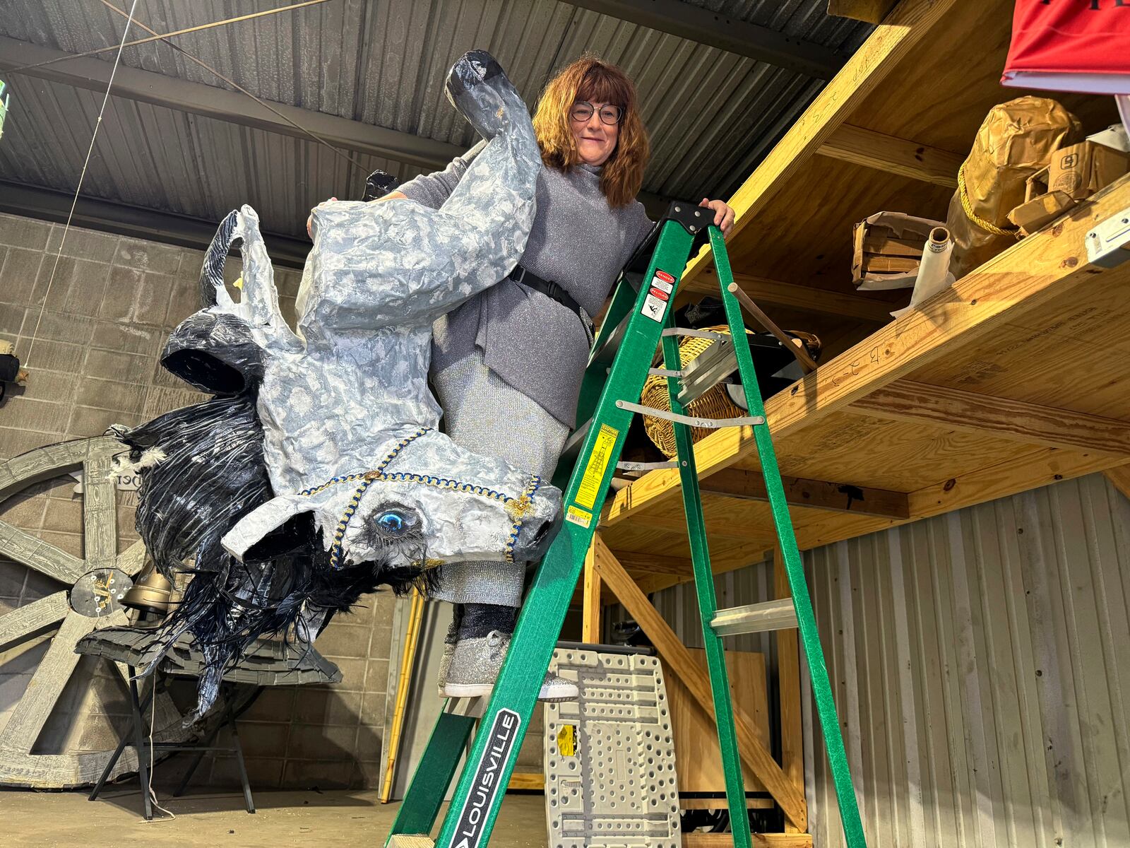 Antoinette de Alteriis gathers props in preparation for the Joan of Arc parade Monday, Jan. 6, 2025, in New Orleans' French Quarter. (AP Photo/Jack Brook)