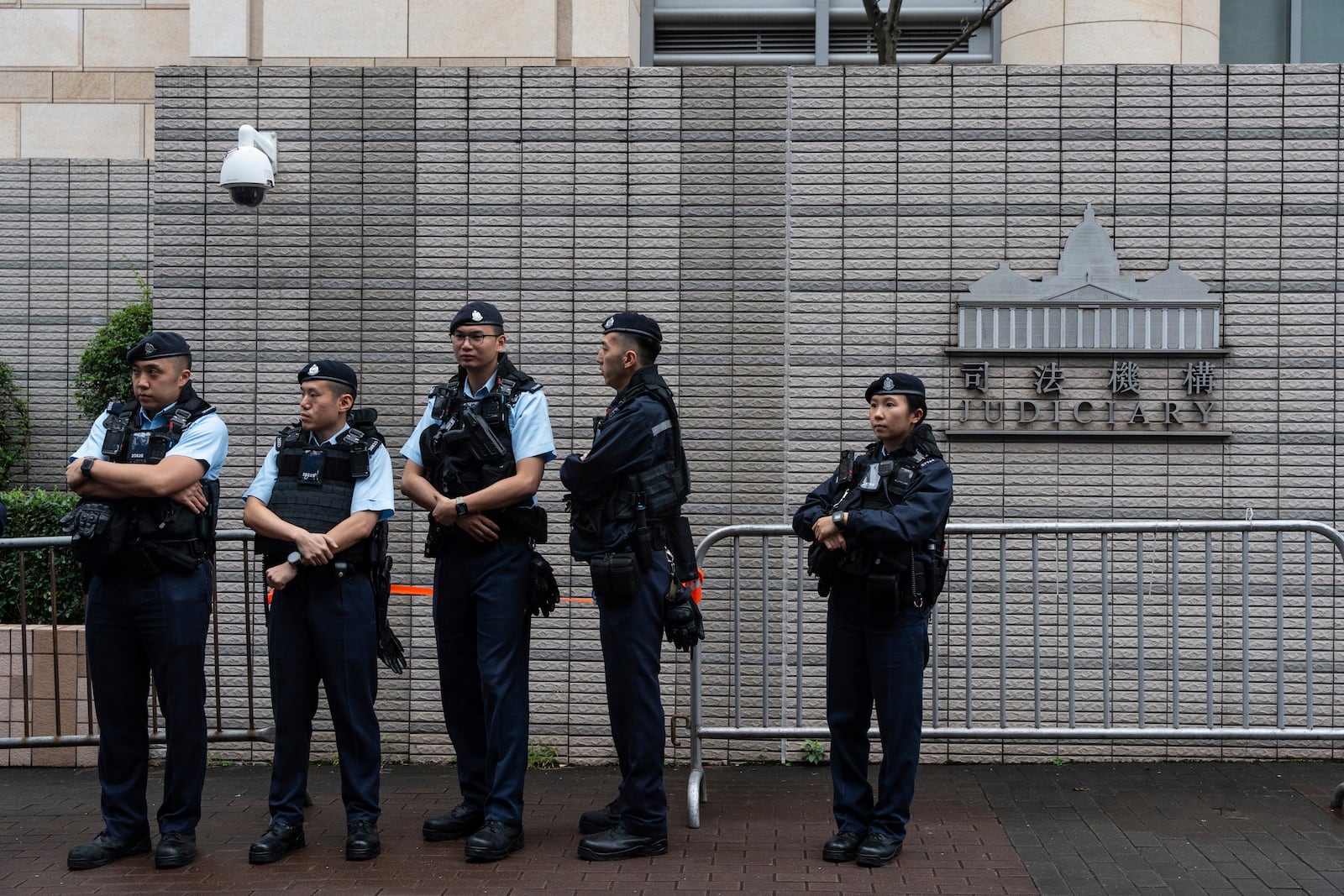 Police officers stand guard outside the West Kowloon Magistrates' Courts in Hong Kong Tuesday, Nov. 19, 2024. (AP Photo/Chan Long Hei)