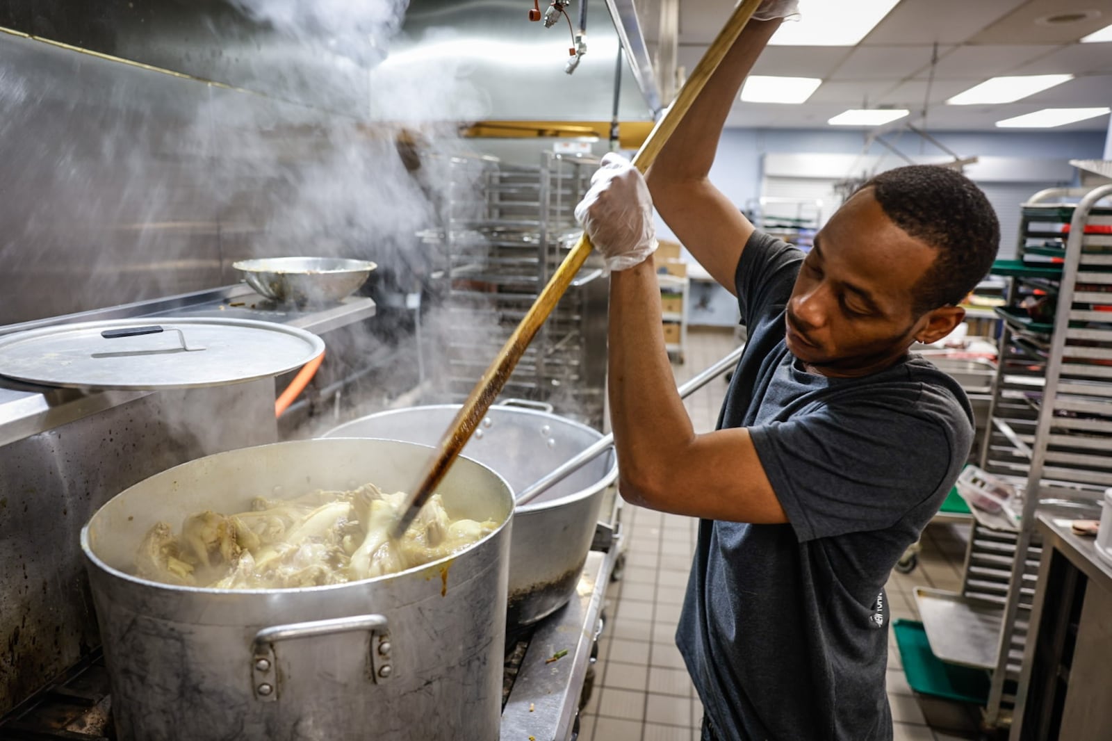 House of Bread chef Daryl Dalton cooks a large pot of chicken for hungry guests on Thursday, Jan. 25, 2024. JIM NOELKER/STAFF