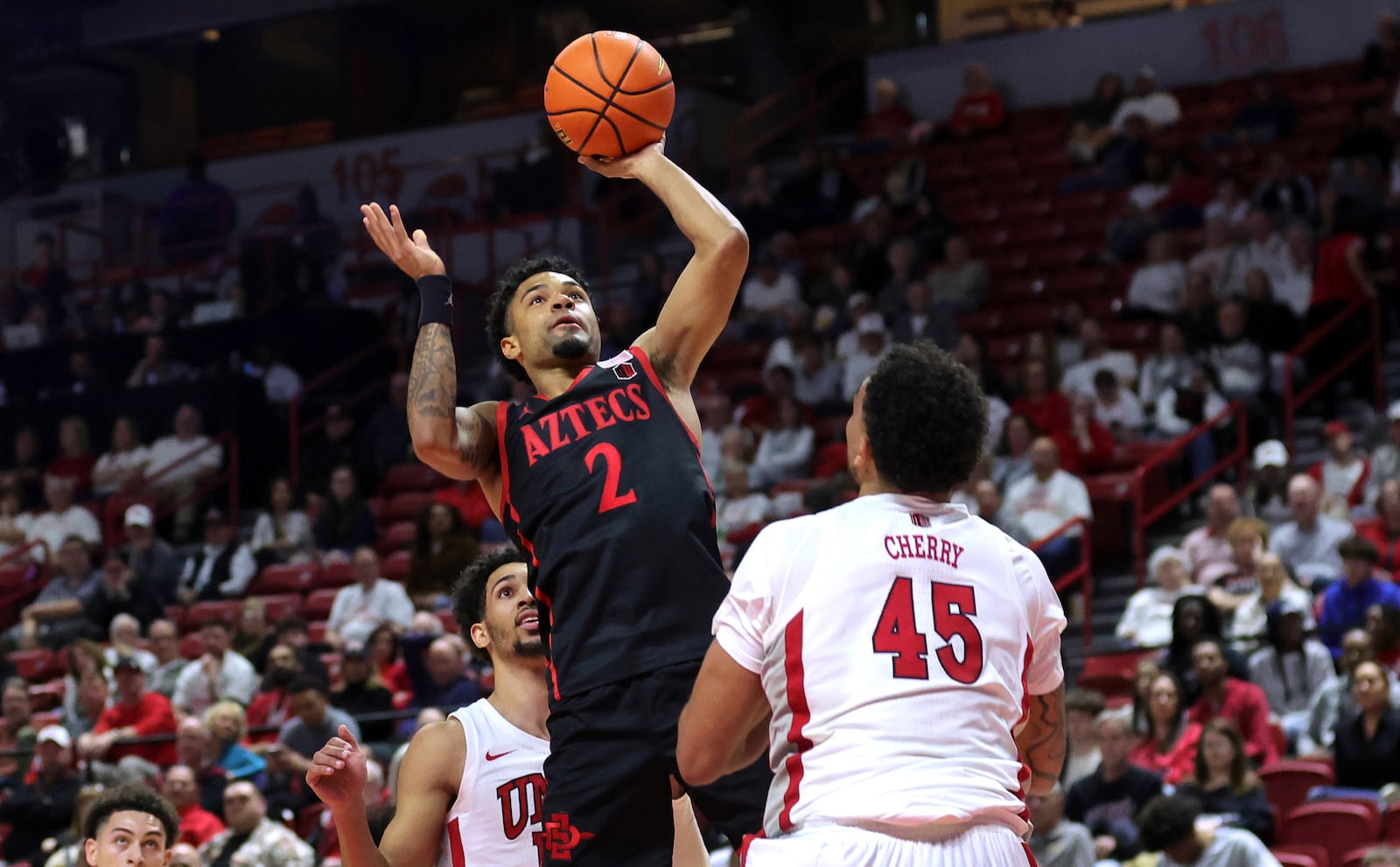 San Diego State guard Nick Boyd (2) shoots over UNLV forward Jeremiah Cherry (45) during the first half of an NCAA basketball game Tuesday, March 4, 2025, in Las Vegas. (Steve Marcus/Las Vegas Sun via AP)