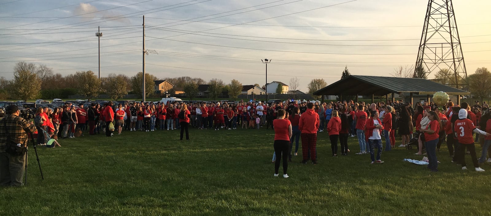 More than 300 mourners gathered Thursday evening in Trenton Community Park to hold a vigil and support the family of Edgewood High School student Hallie Deaton. Deaton died earlier this week after a car crash in nearby Wayne Twp. Family members asked supporters to wear red - Deaton's favorite color - and bring red balloons, which were released into the air, to honor her untimely passing. (Photo By Michael D. Clark/Journal-News)