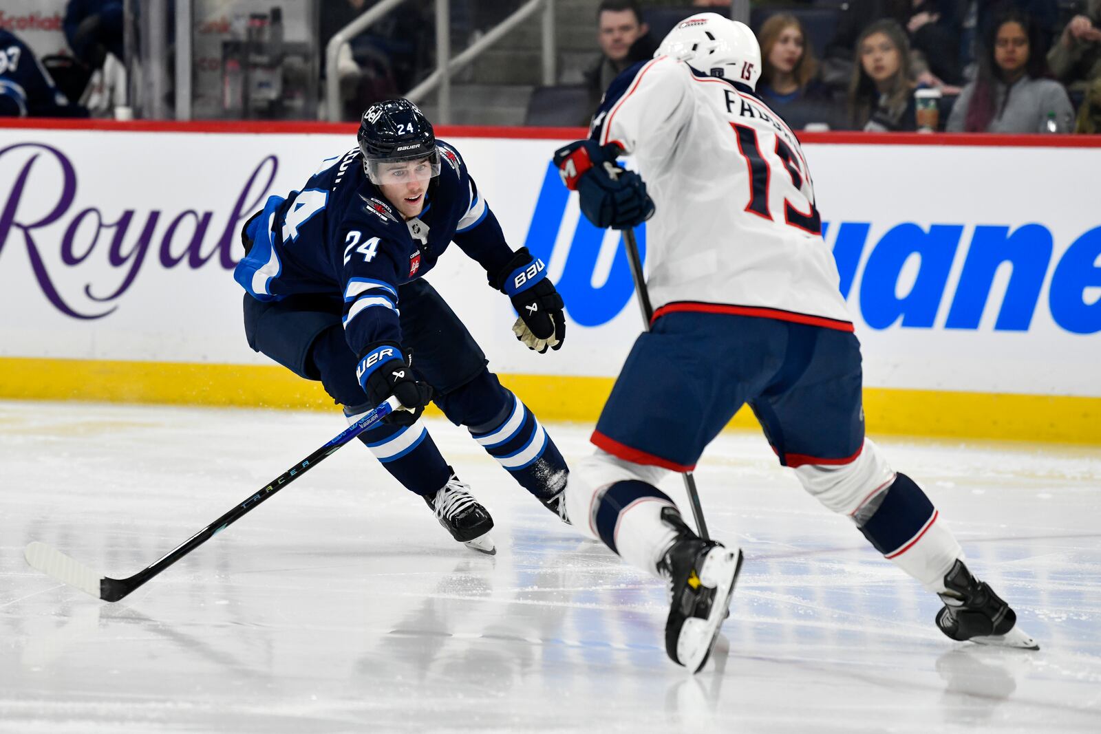 Winnipeg Jets' Haydn Fleury (24) chases Columbus Blue Jackets' Dante Fabbro (15) during the second period of an NHL hockey game in Winnipeg, Canada Sunday, Dec. 8, 2024. (Fred Greenslade/The Canadian Press via AP)